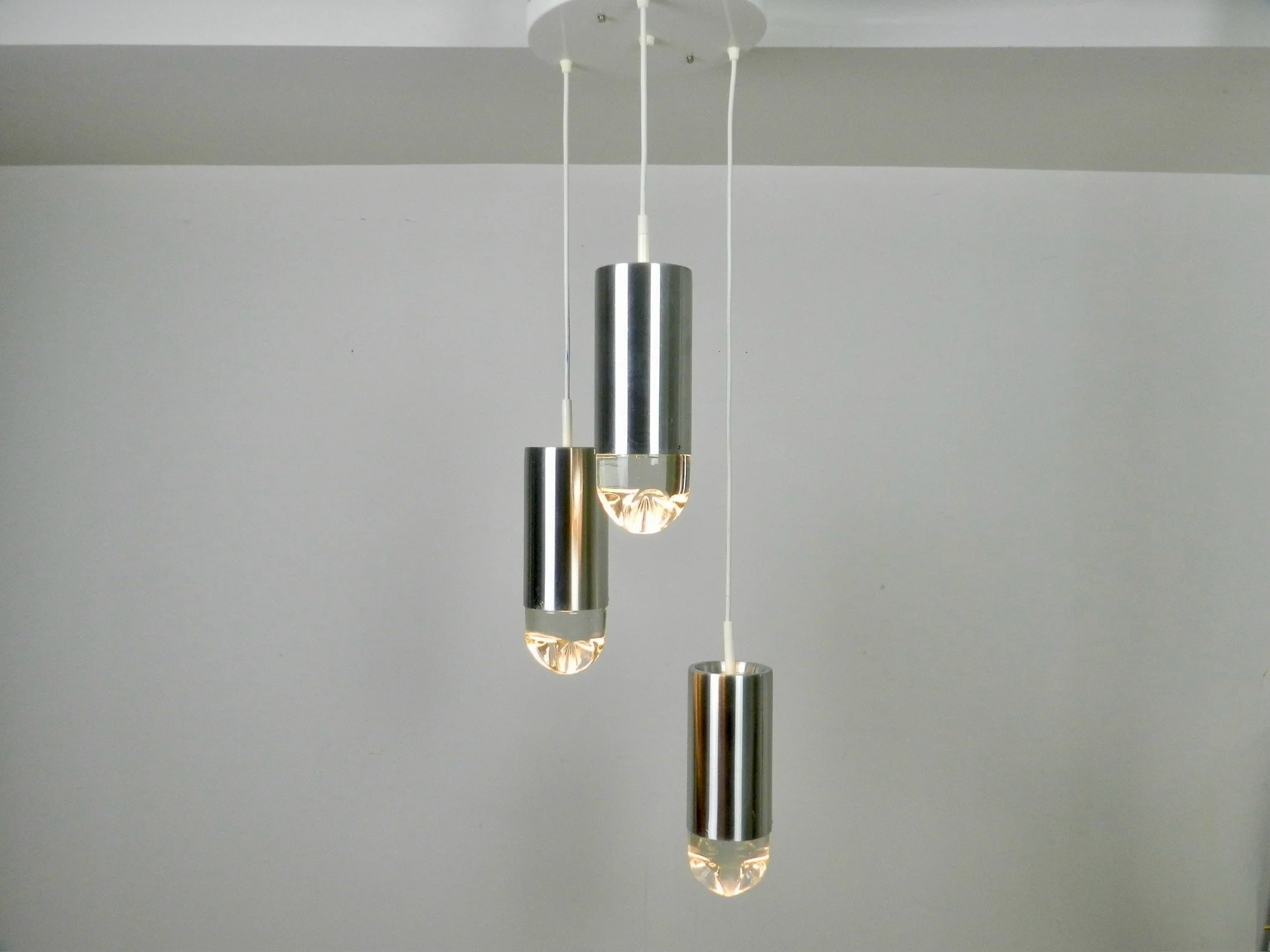 Cascade light fixture by Raak. Aluminum with heavy clear glass shades.  Netherlands, 1970s.