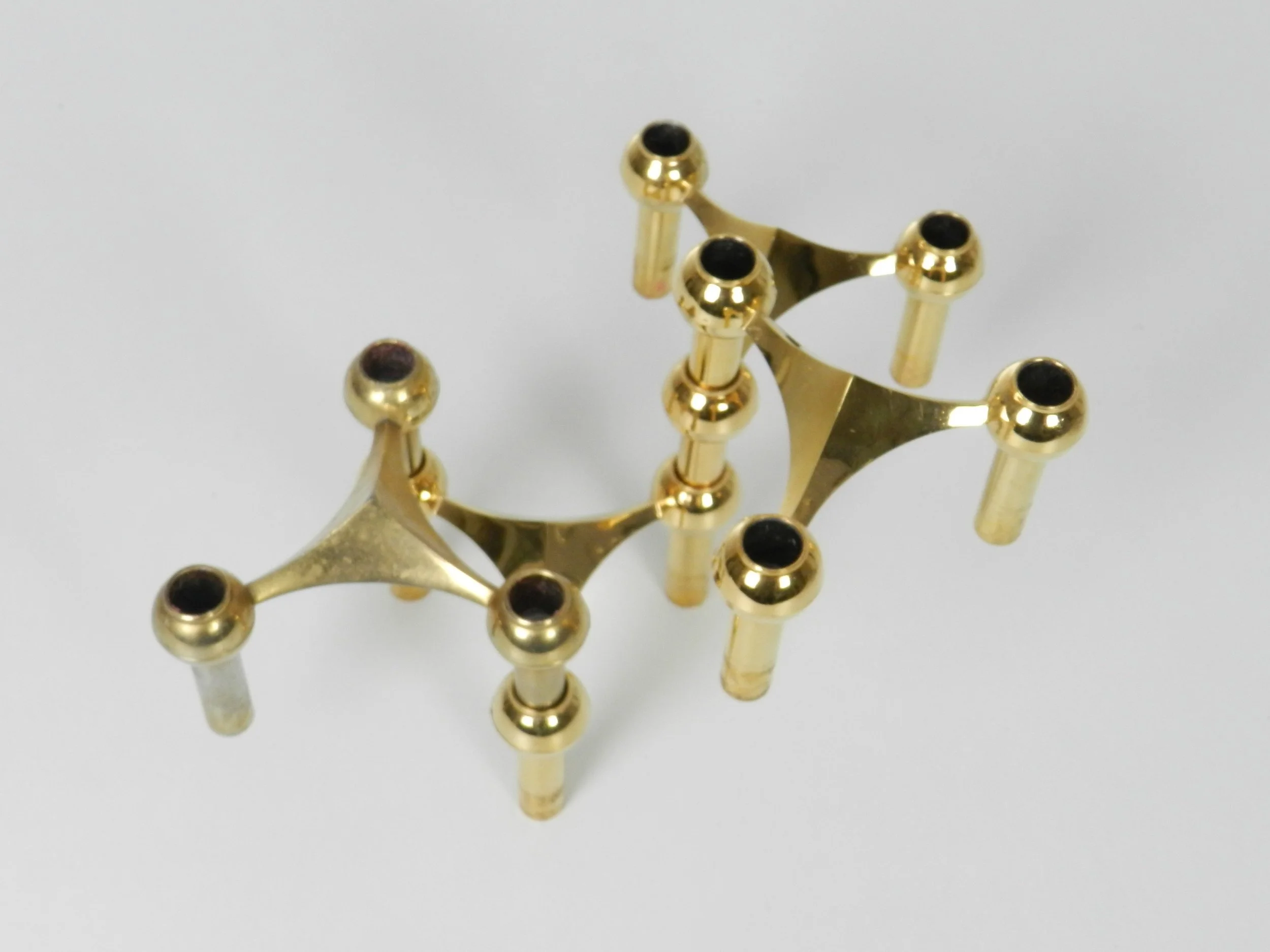 Set of 4 brass modular Nagel candle holders designed by Fritz Nagel and Ceasar Stoffi.  Germany, 1970s.