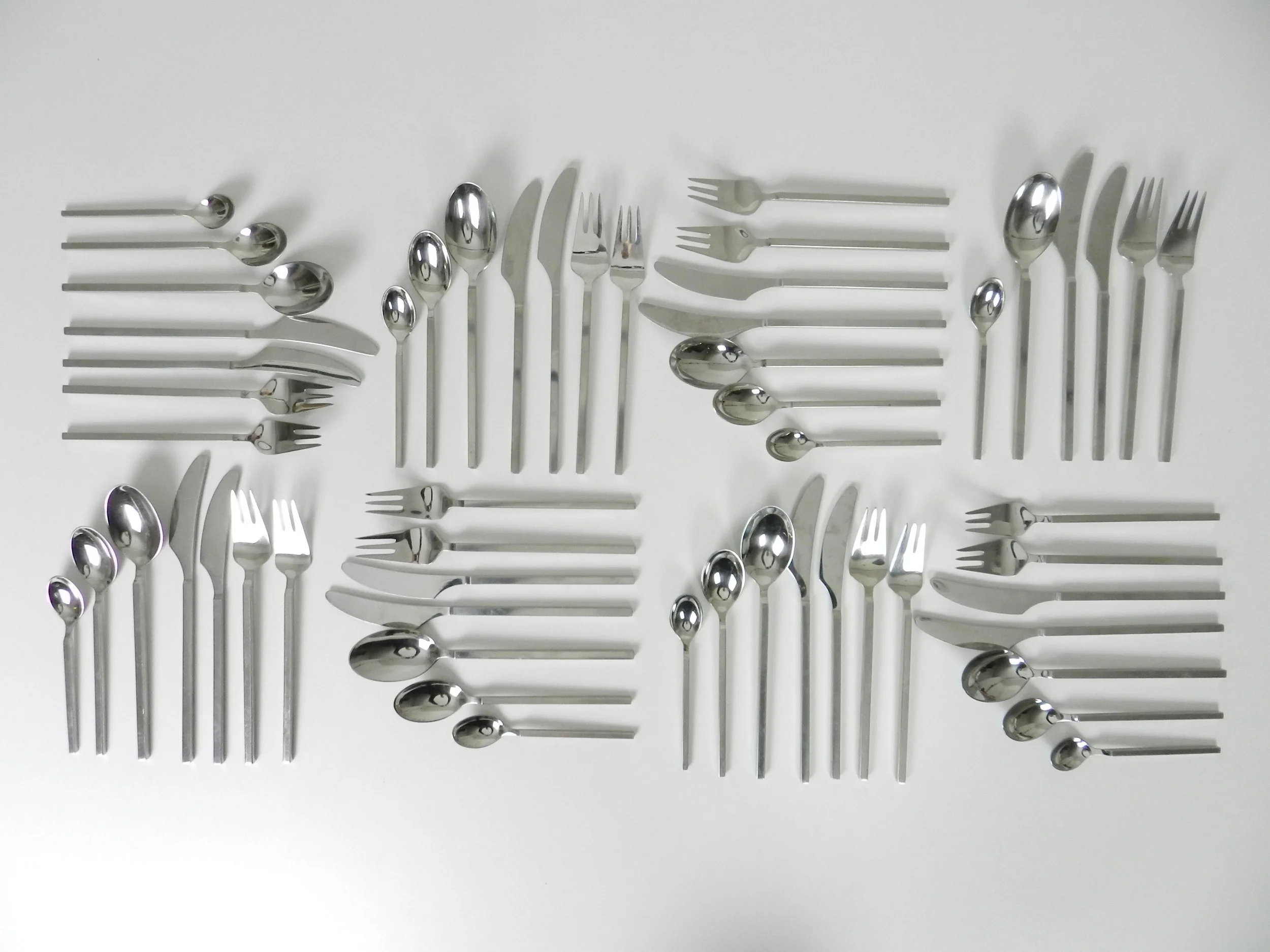 Stainless steel “Rondo” flatware set designed by Per Willemoes for Lundtofte. 8 - seven piece place settings (missing one tea spoon) plus 6 serving pieces, total of 61 pieces.  Denmark, 1970s.
