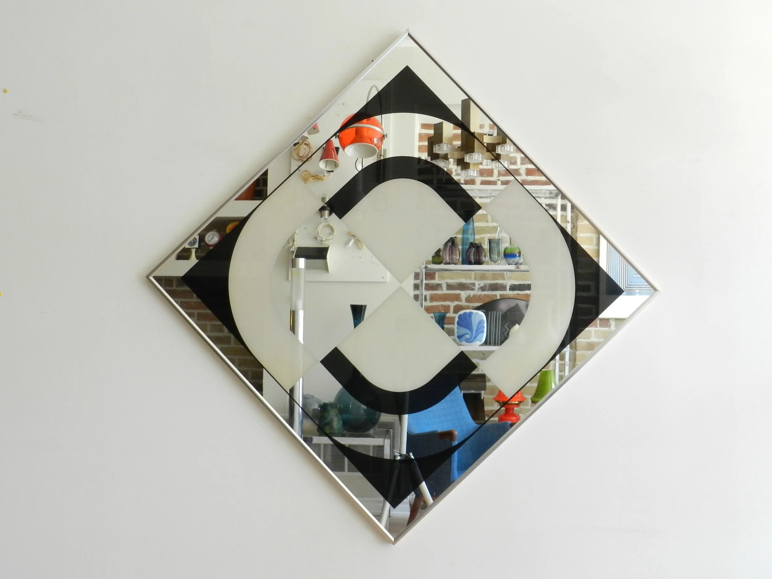 Op Art graphic mirror by Turner Design. Can be hung horizontally or diagonally.  USA, 1970s.