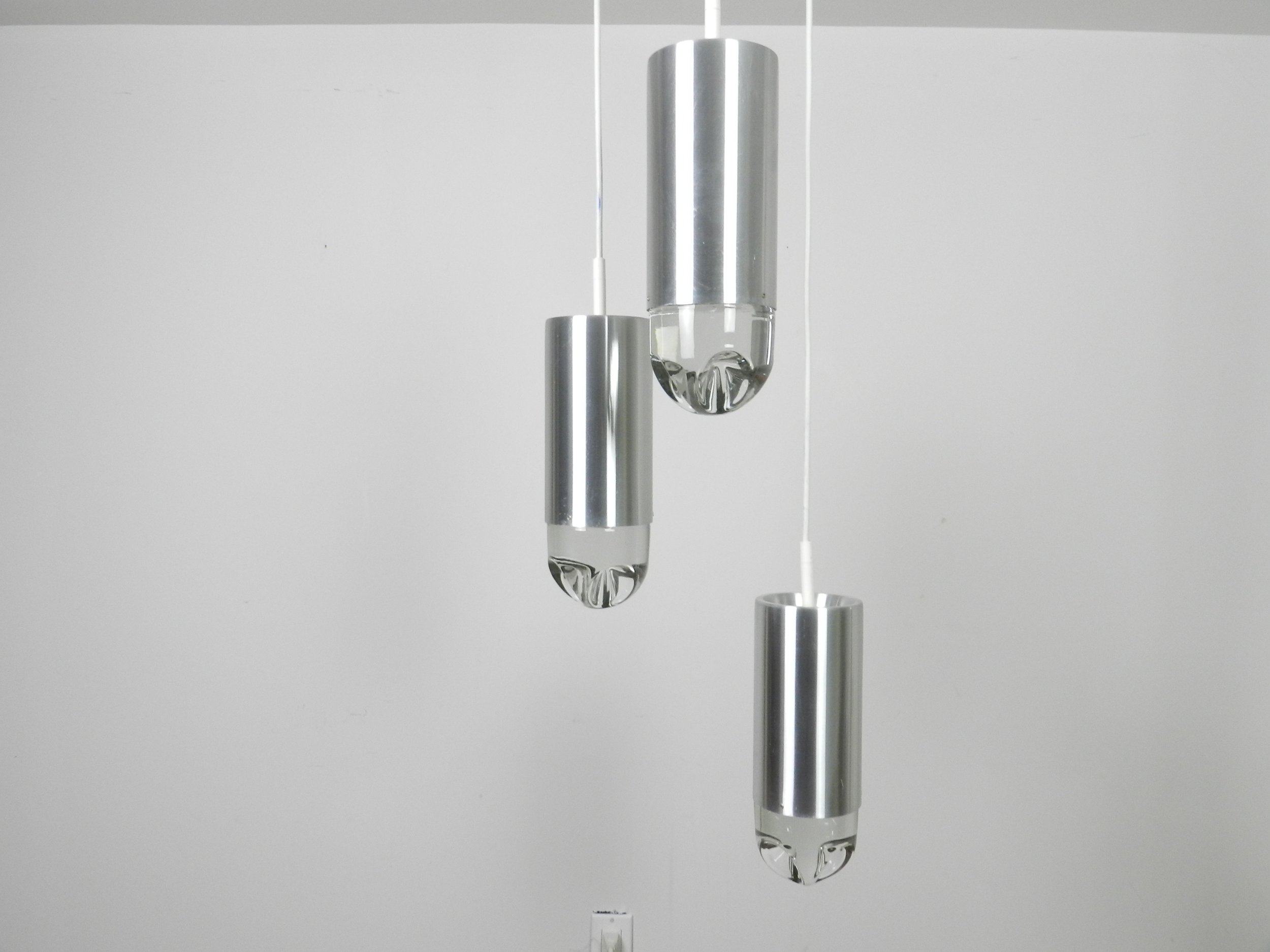 Cascade light fixture by Raak. Aluminum with heavy clear glass shades.  Netherlands, 1970s.
