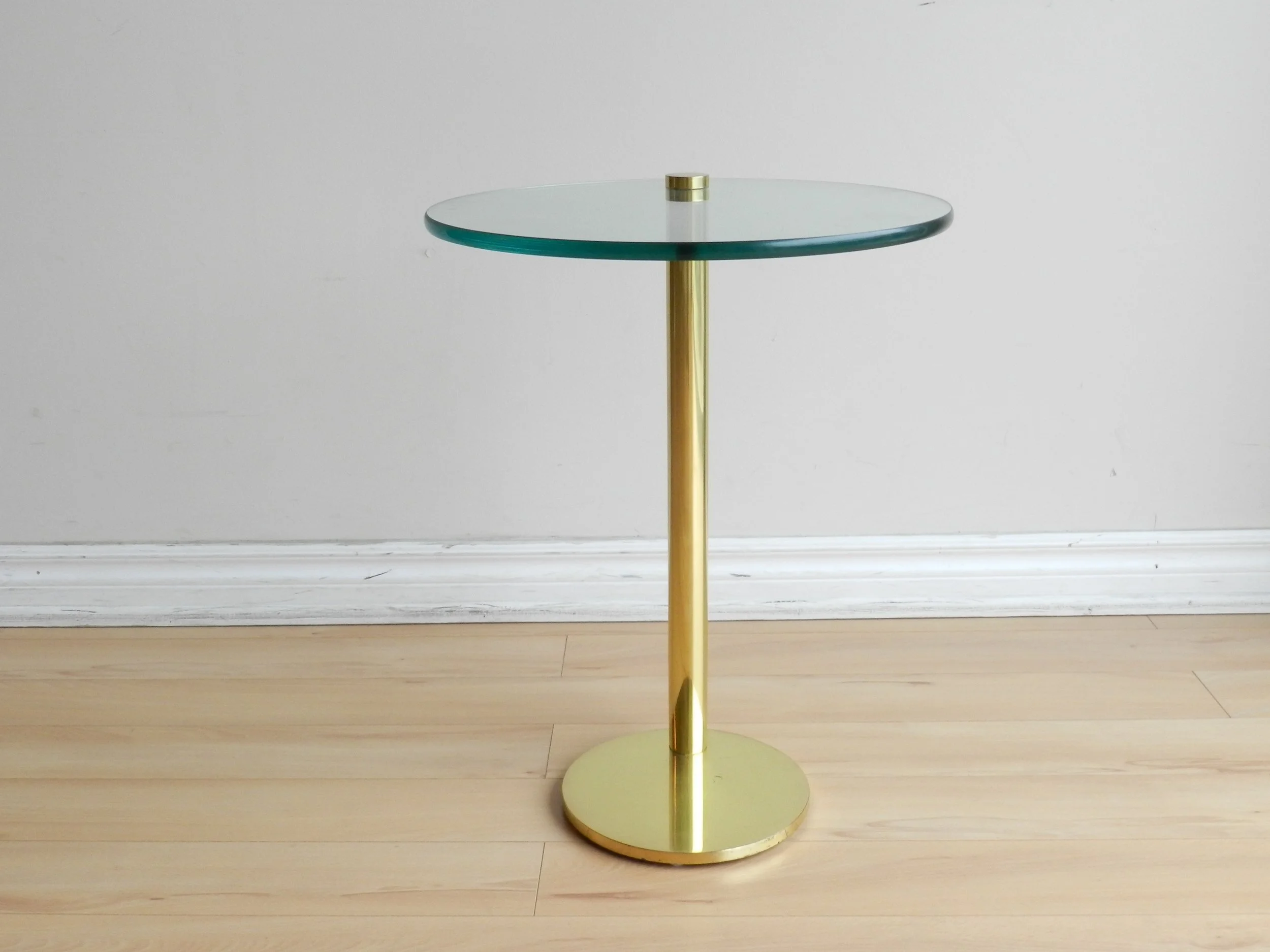 Post modern side table in brass with cantilevered glass top attributed to Prismatique.  Canada, 1980s.
