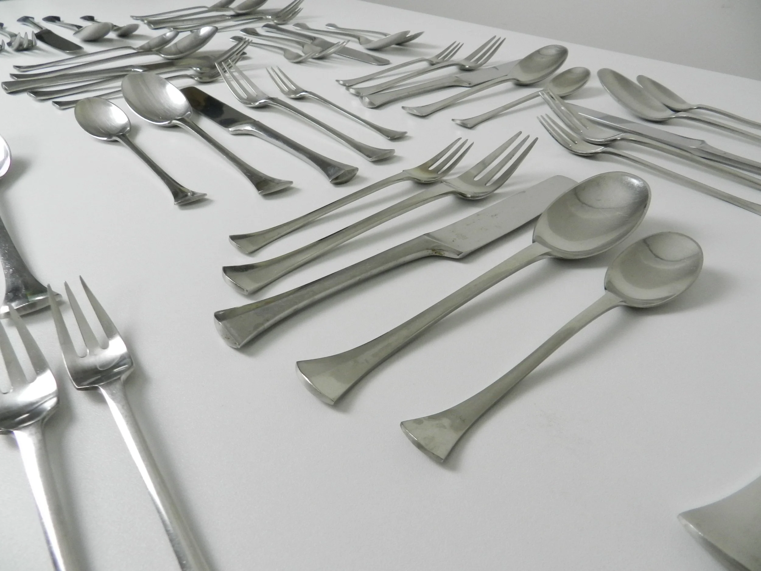 Stainless steel Thistle flatware set designed by Jens Quistgaard for Dansk. France, 1960s.