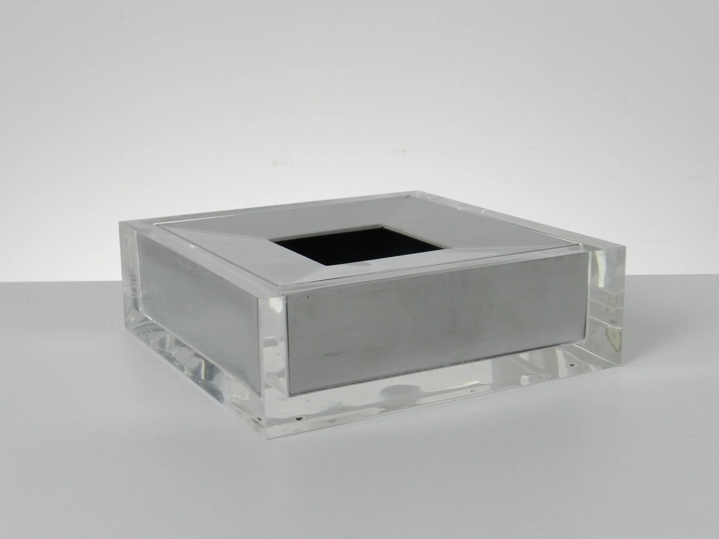 Lucite and chrome ashtray designed by Fabio Manlio Ciocca for Guzzini.  Italy, 1970s.