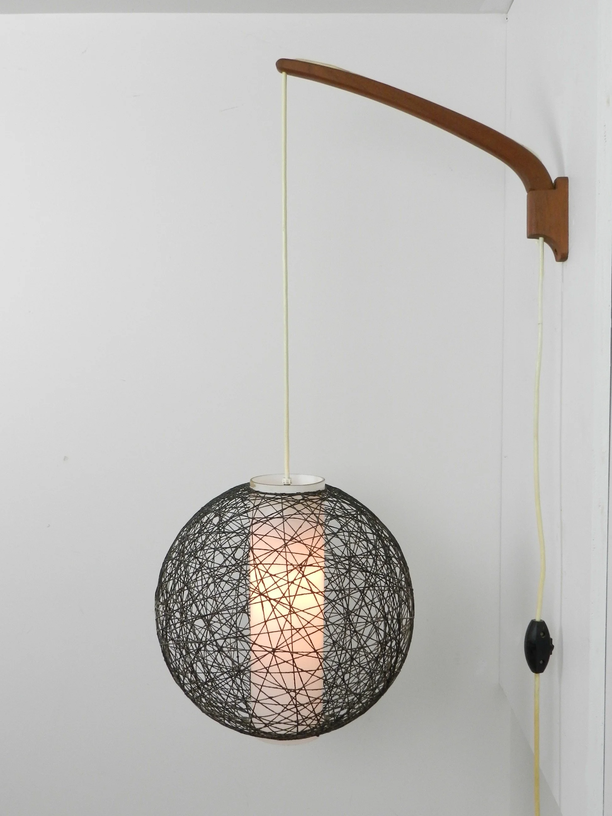 Scandinavian mid century wall lamp in teak with glass and string shade.  Finland, 1960s.