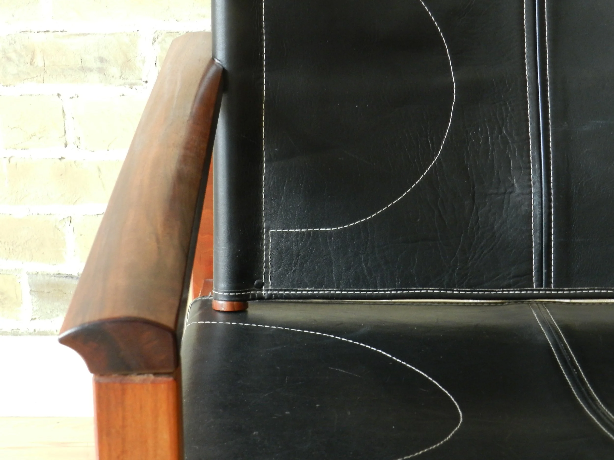 Peglev rocking chair designed by Michel Amoult for Mobilia Cotemporanea. Rosewood with leather upholstery.  Brazil, 1960s.