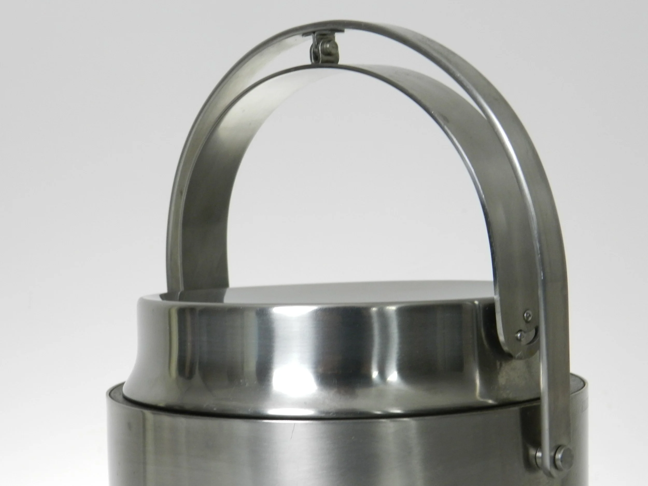 Stainless steel ice bucket with mechanical lid, glass interior and plastic liner. Designed by Anselmo Vitale and Carlo Mazzeri for Alessi.  Italy, 1970s.