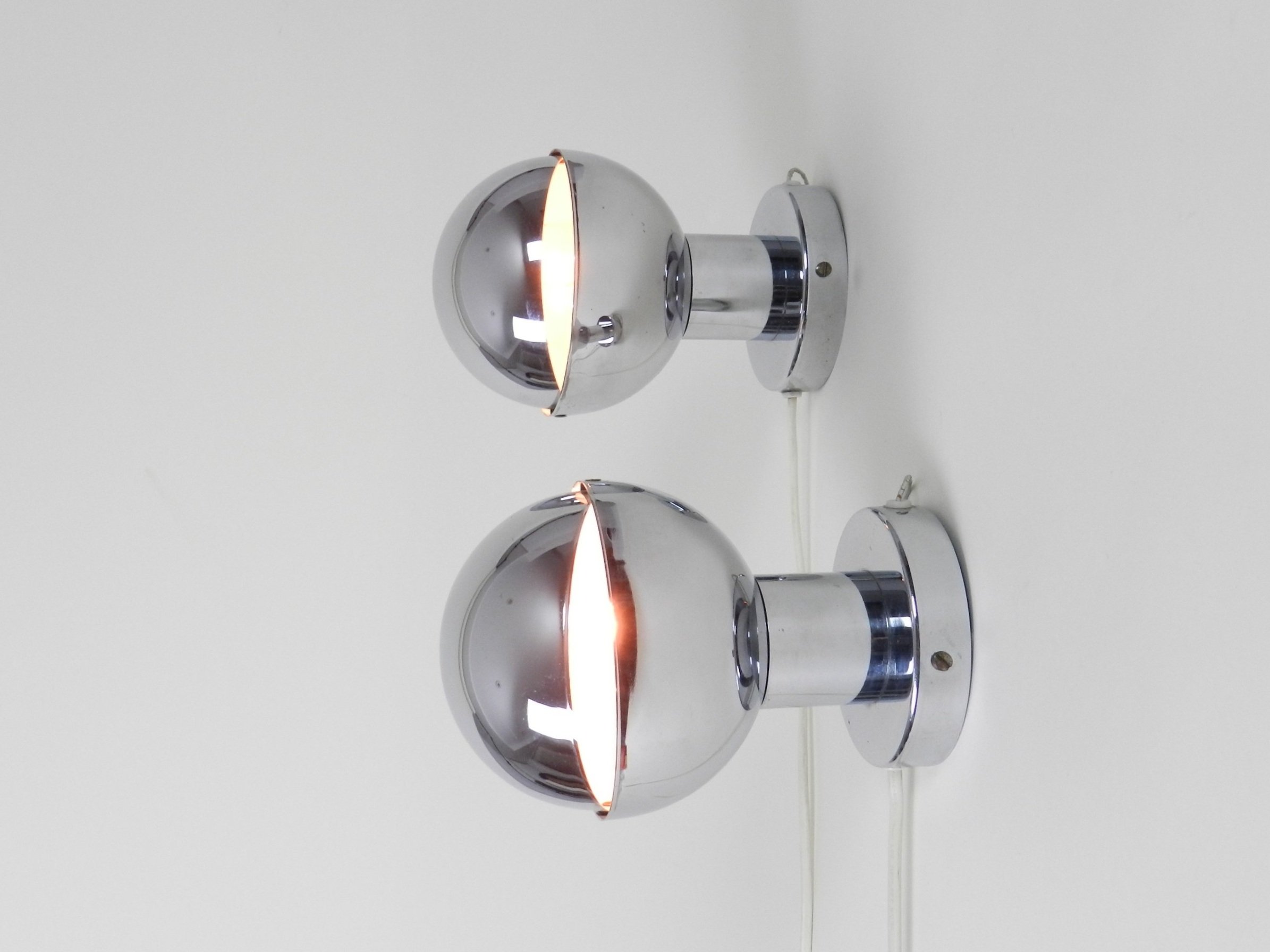 Pair of space age chrome eclipse wall lamps. Netherlands, 1970s.