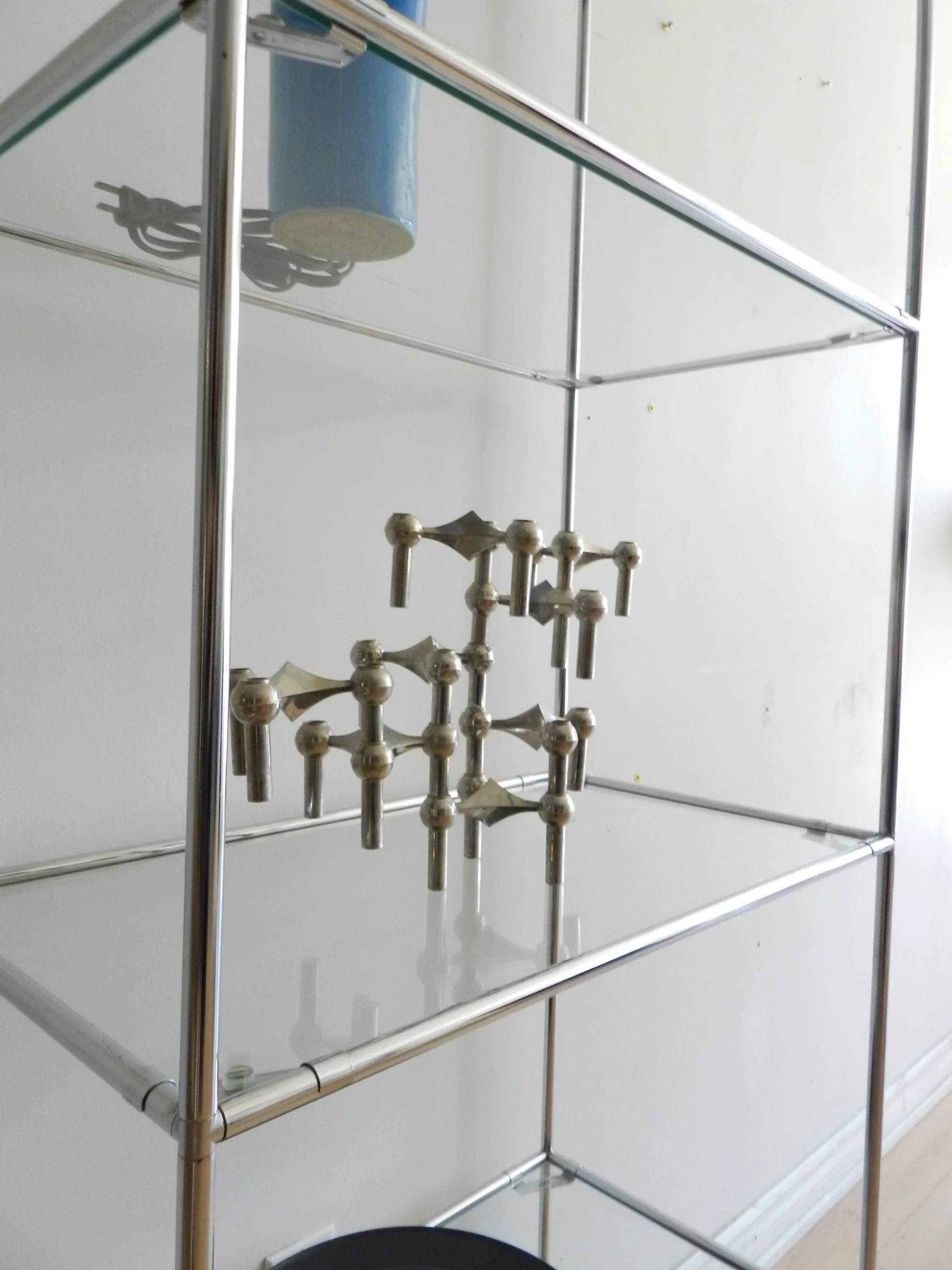 Pair of Abstracta chrome and glass modular shelf units designed by Poul Cadovius for Royal System.  Denmark, 1970s.