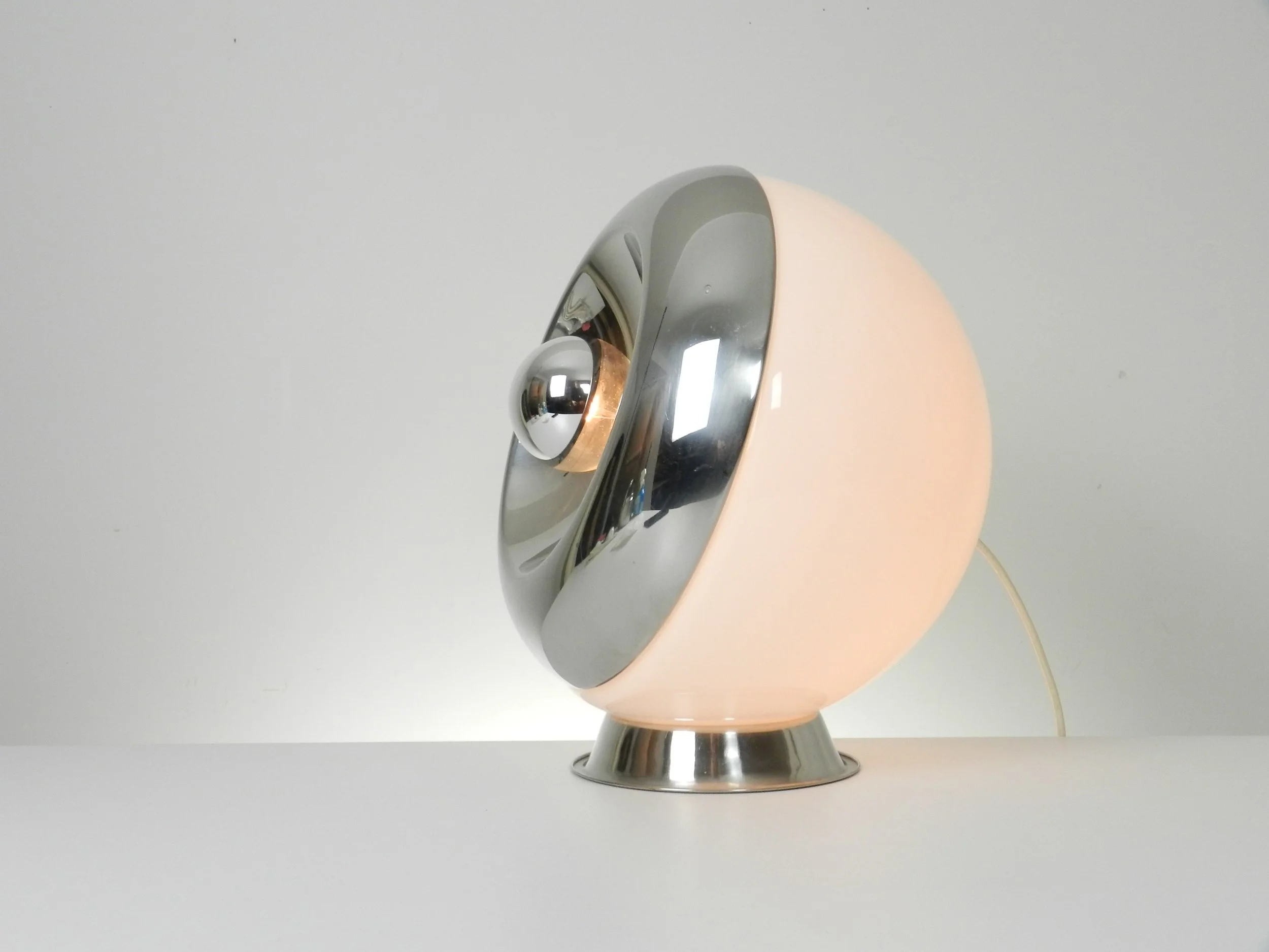 Large space age lamp in opaline glass and chrome by Reggiani. Can be used as a table or floor lamp.  Italy, 1970s.