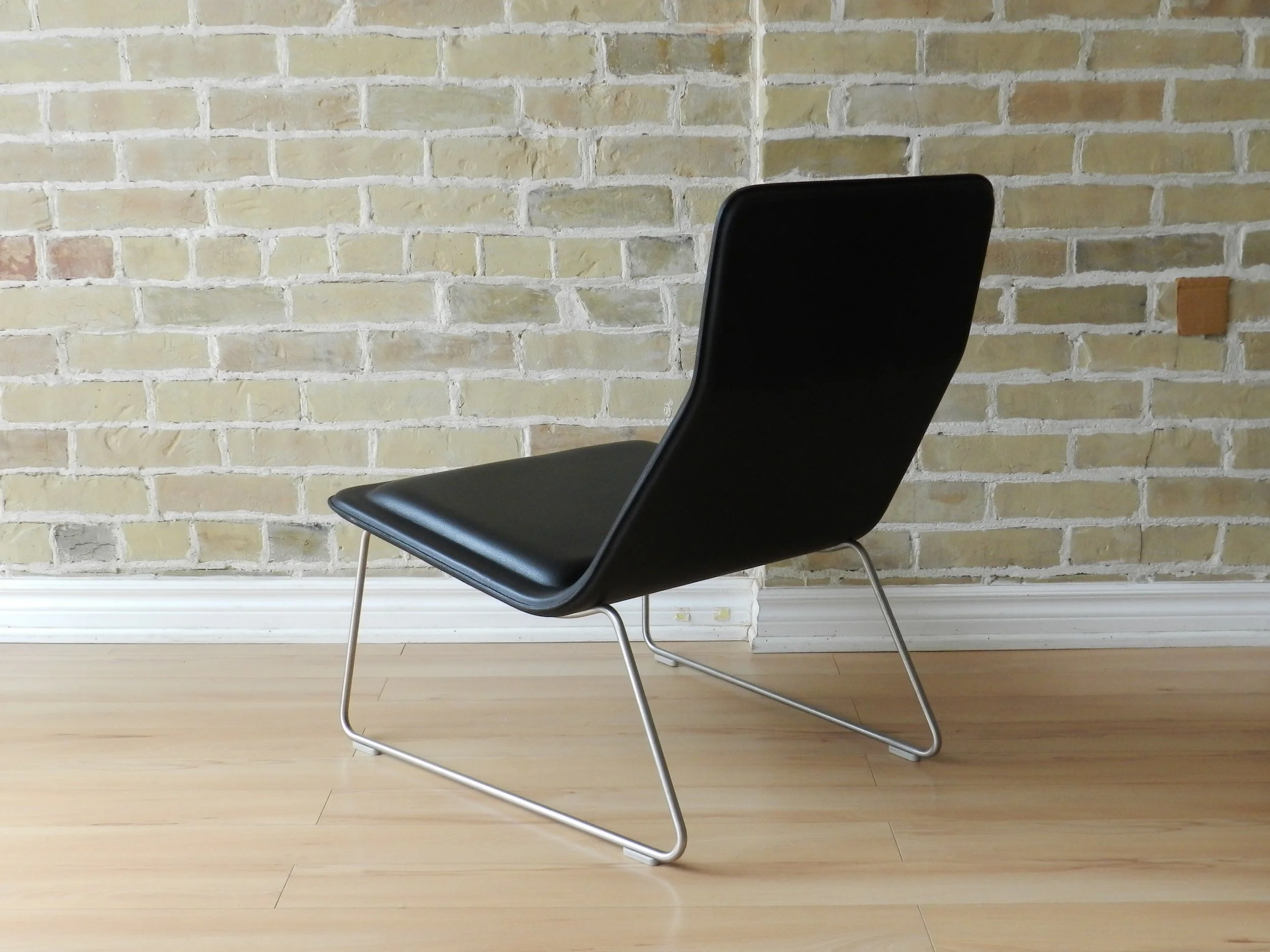 Pair of Low Pad lounge chairs designed by Jasper Morrison for Cappellini. Black leather upholstery on steel bases.  Italy, 1999.
