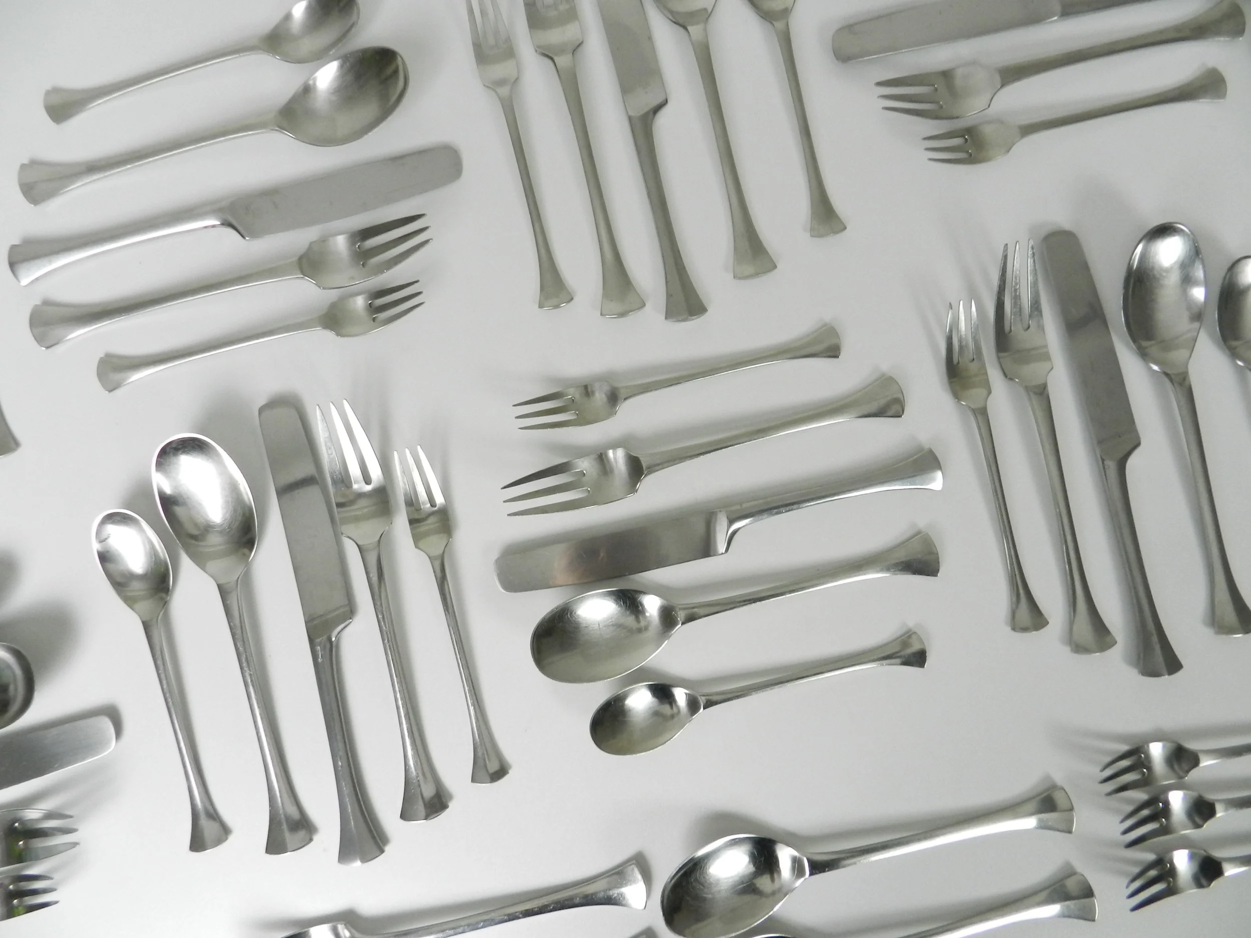 Stainless steel Thistle flatware set designed by Jens Quistgaard for Dansk. France, 1960s.