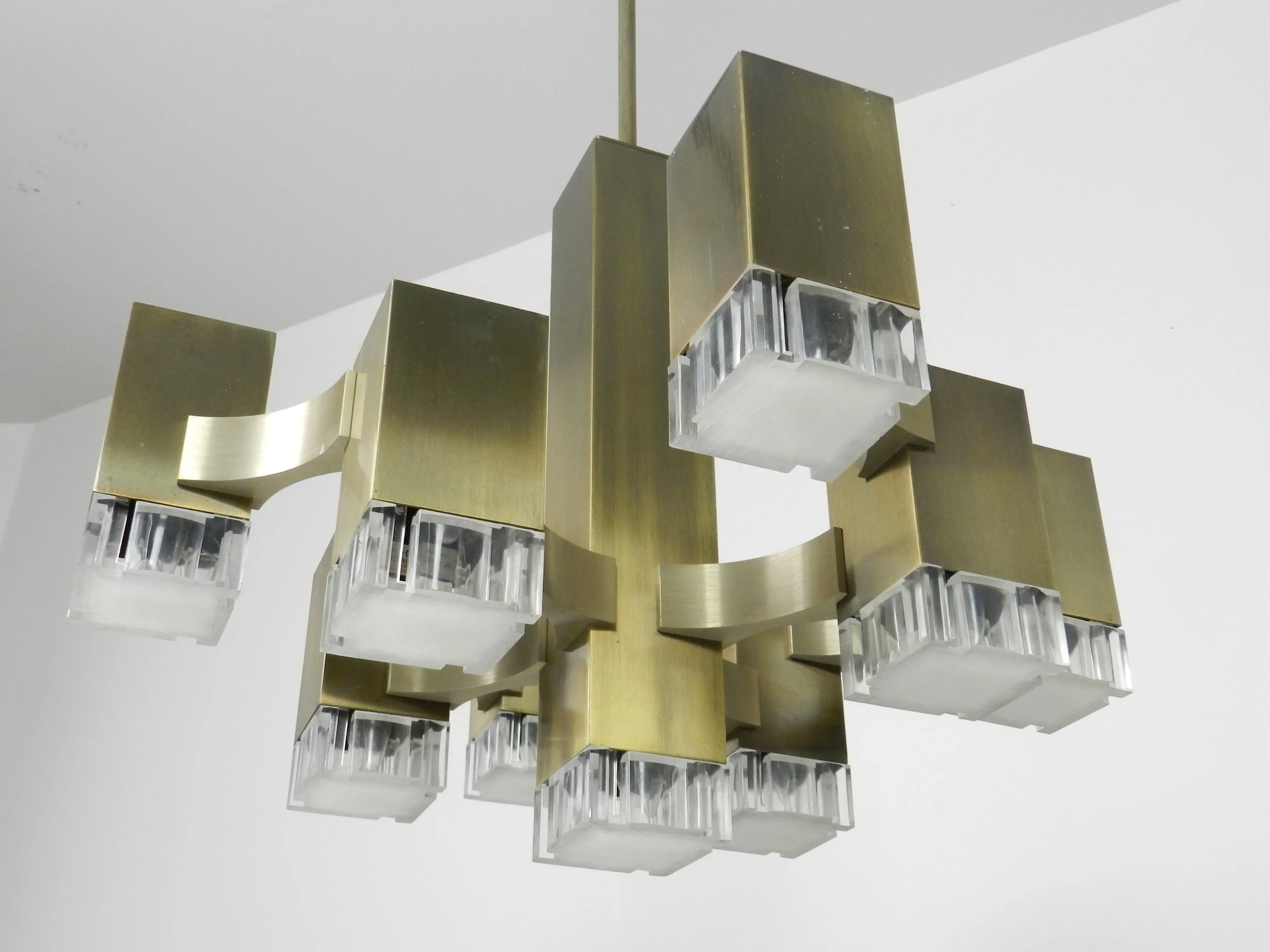 Modernist nine light “Cubic” chandelier designed by Gaetano Sciolari. In bronze plated metal with acrylic diffusers.  Italy, 1960s.