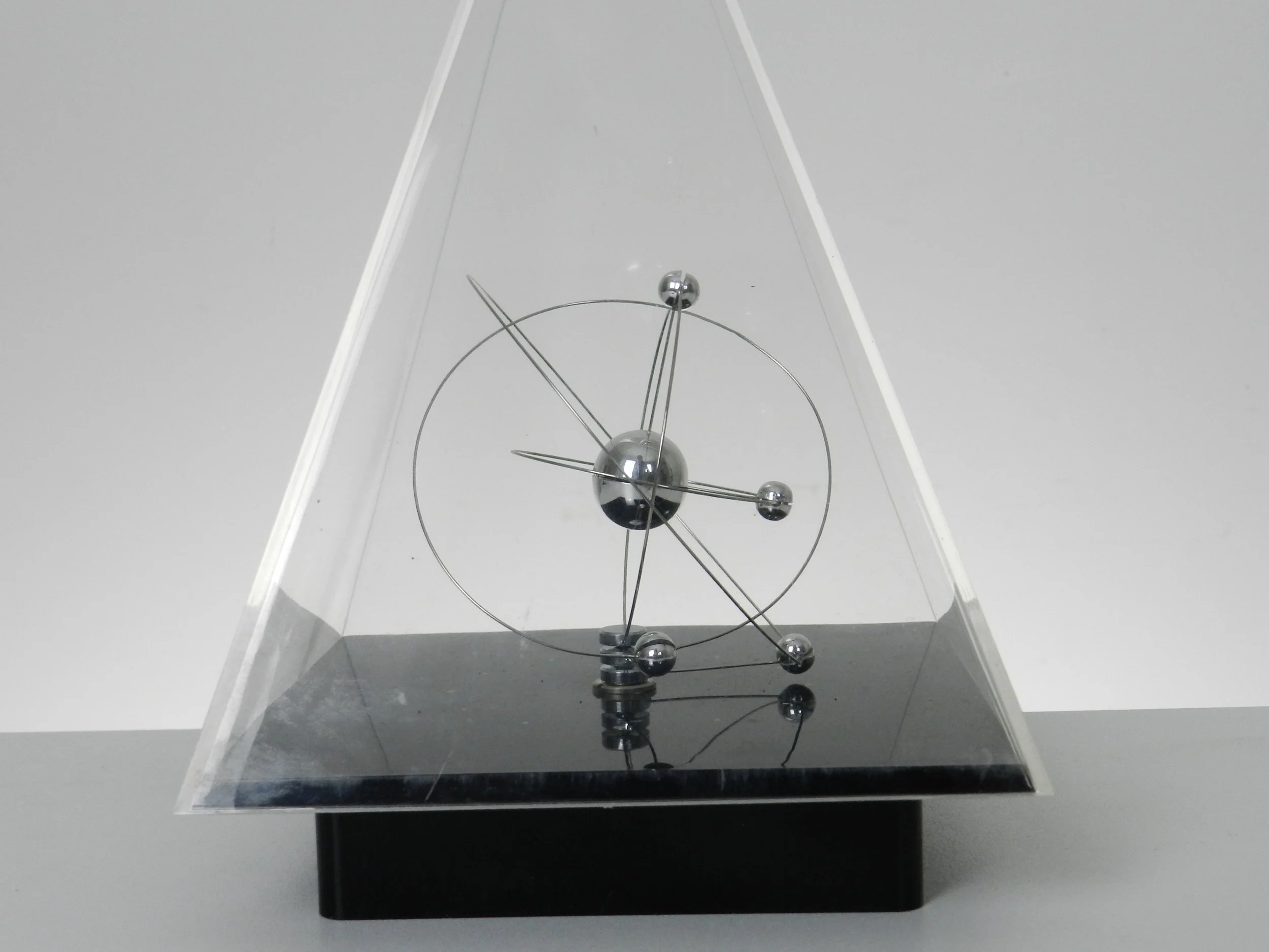 Space age planetary orbit clock in clear and black acrylic with chrome wires.  circa 1980s.
