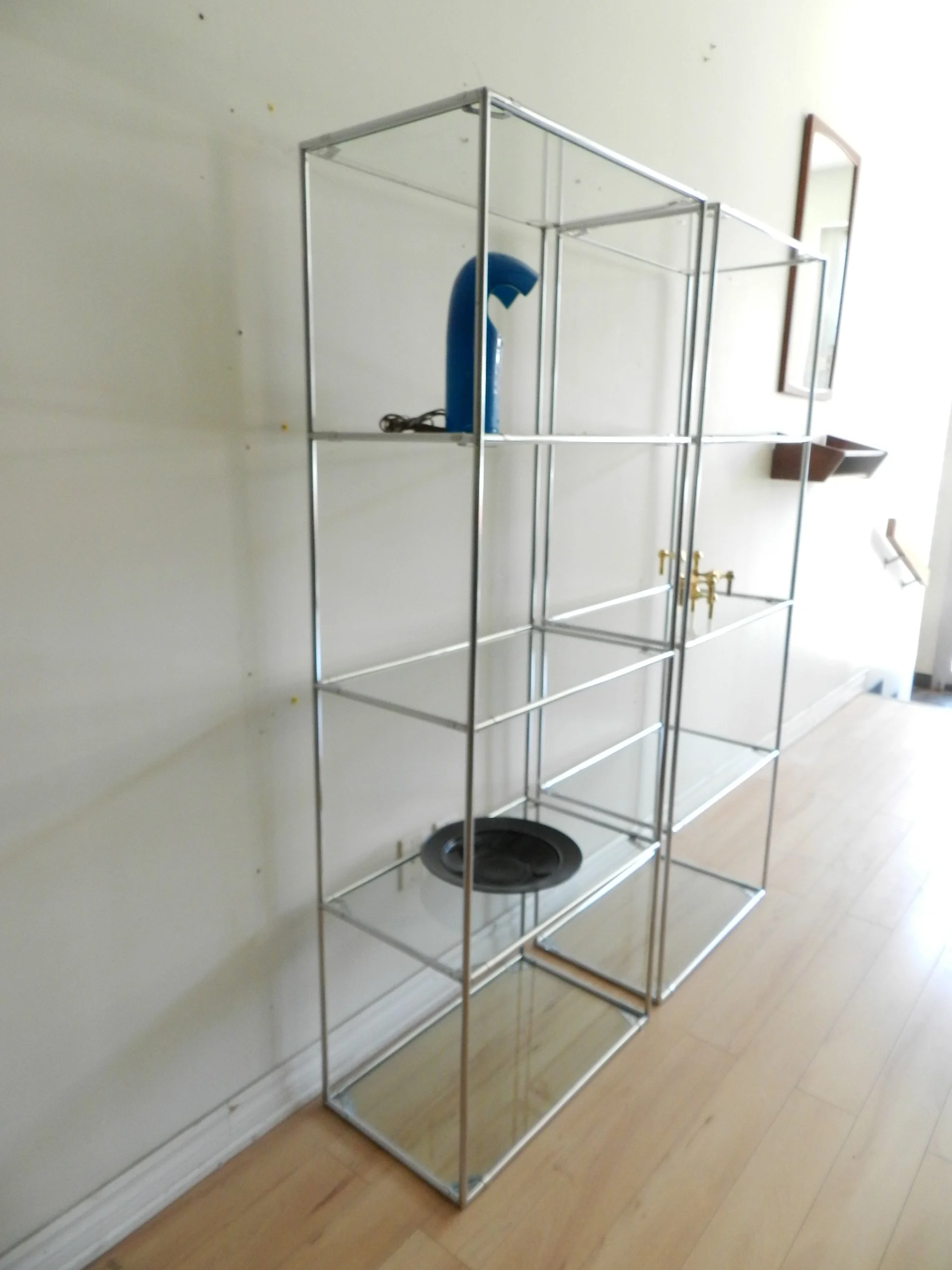Pair of Abstracta chrome and glass modular shelf units designed by Poul Cadovius for Royal System.  Denmark, 1970s.