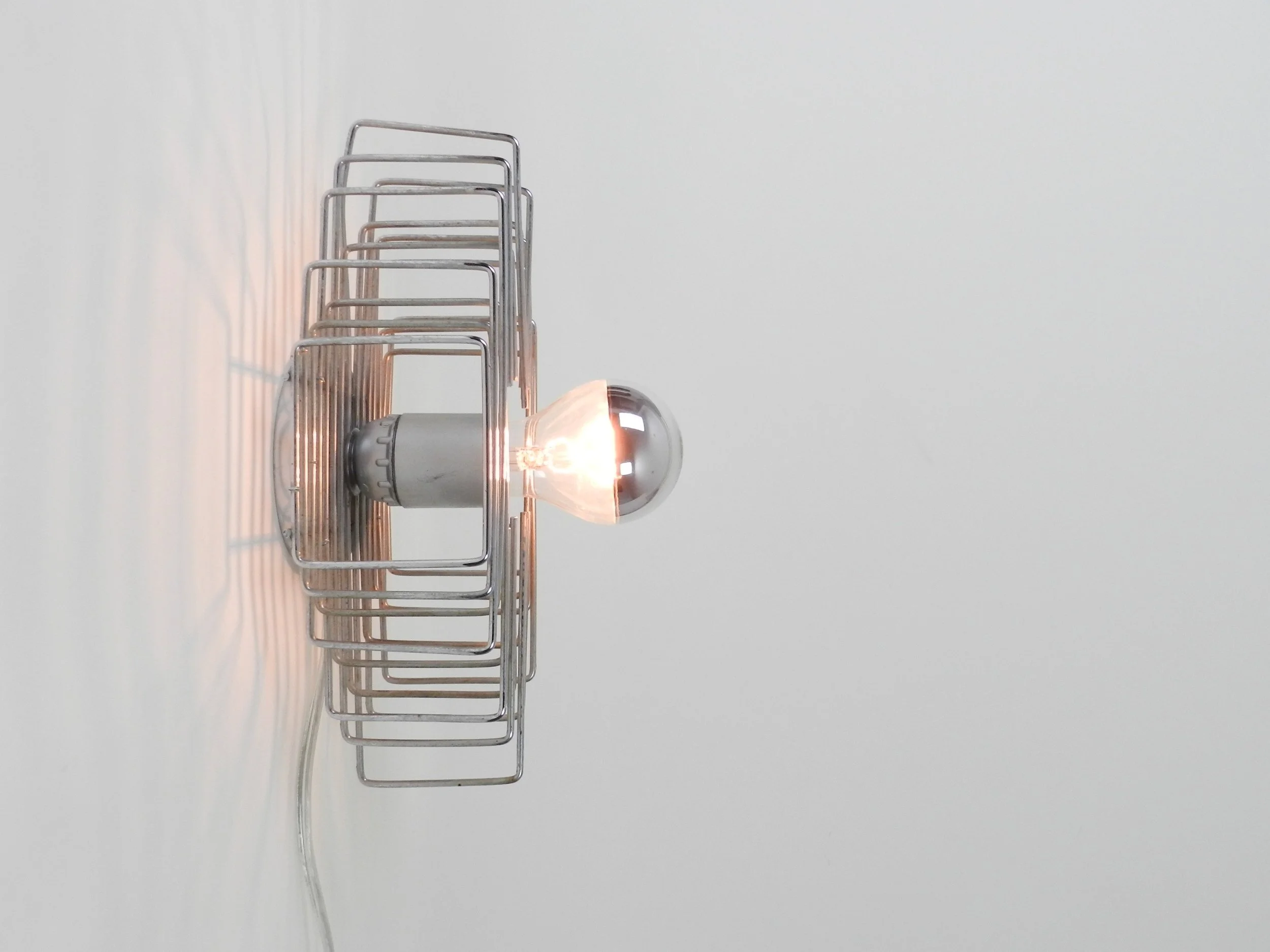 Modernist wall lamp in chrome wire.  circa 1970s.