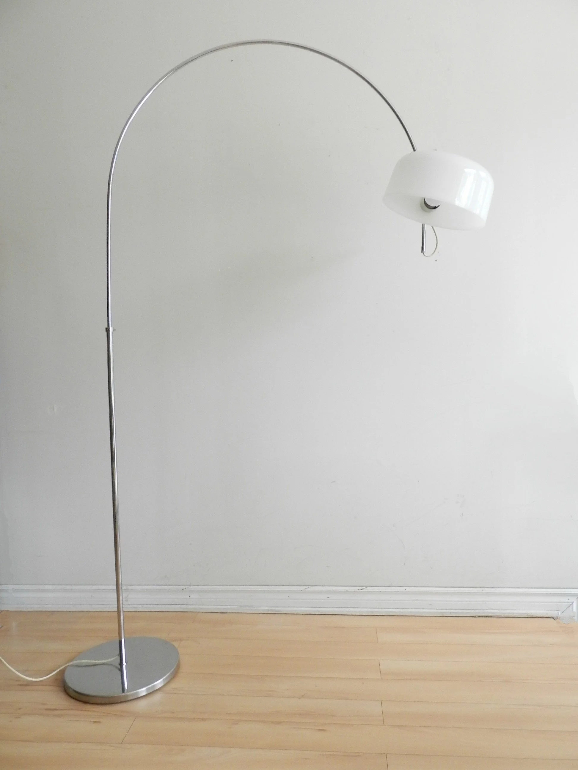 Modernist arc floor lamp by Raak. Chromed steel with acrylic shade and lucite hardware.  Netherlands, 1970s.