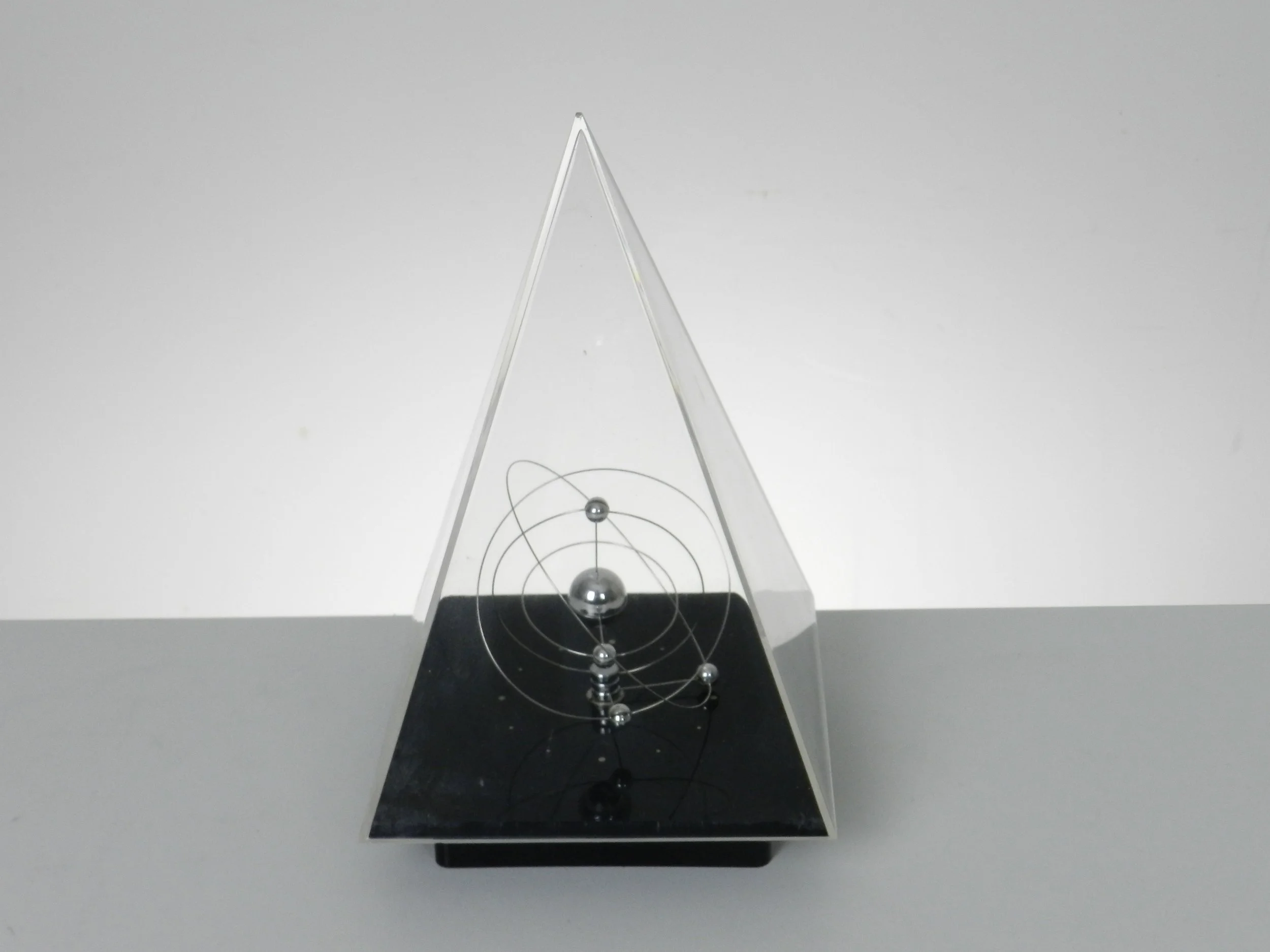 Space age planetary orbit clock in clear and black acrylic with chrome wires.  circa 1980s.