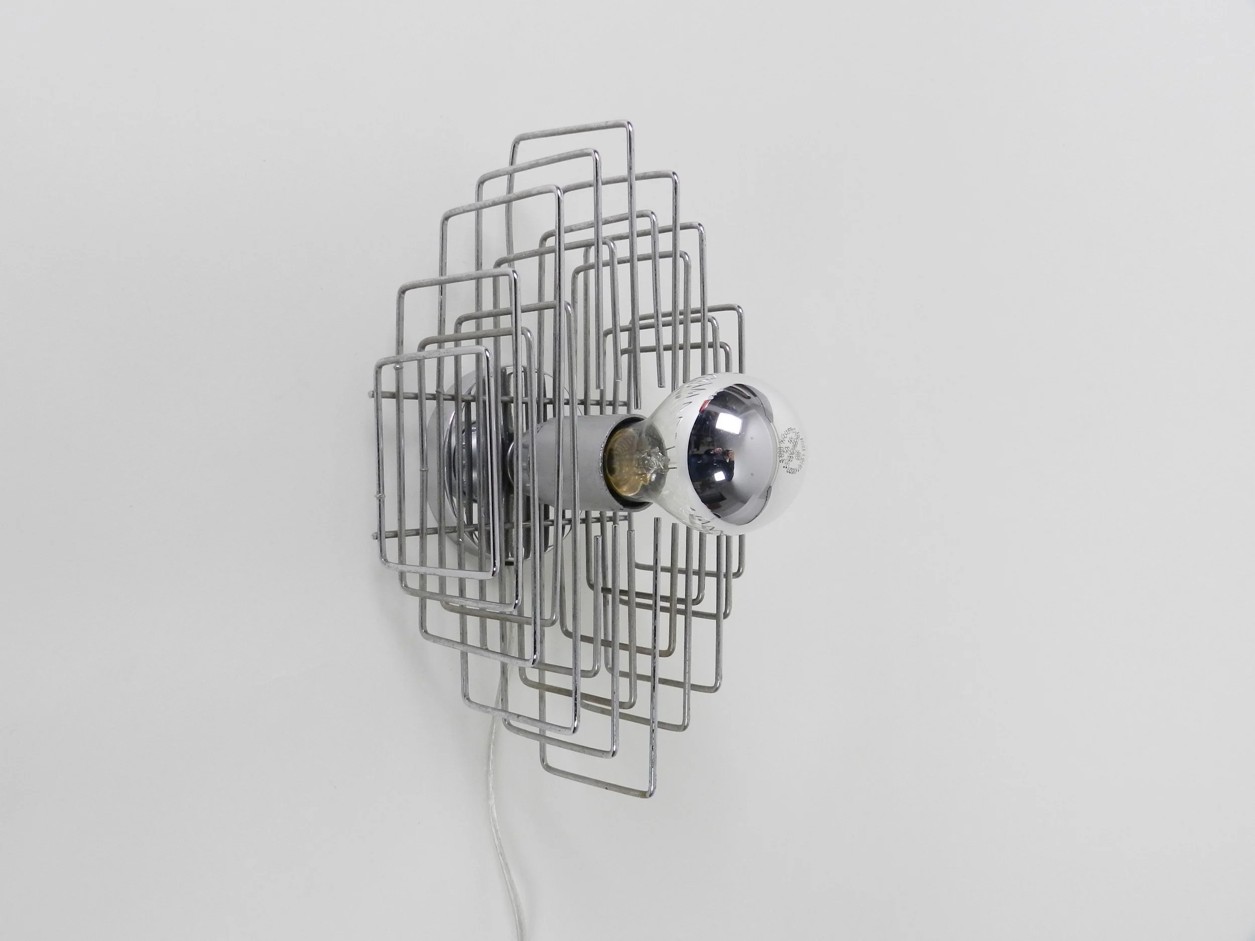 Modernist wall lamp in chrome wire.  circa 1970s.