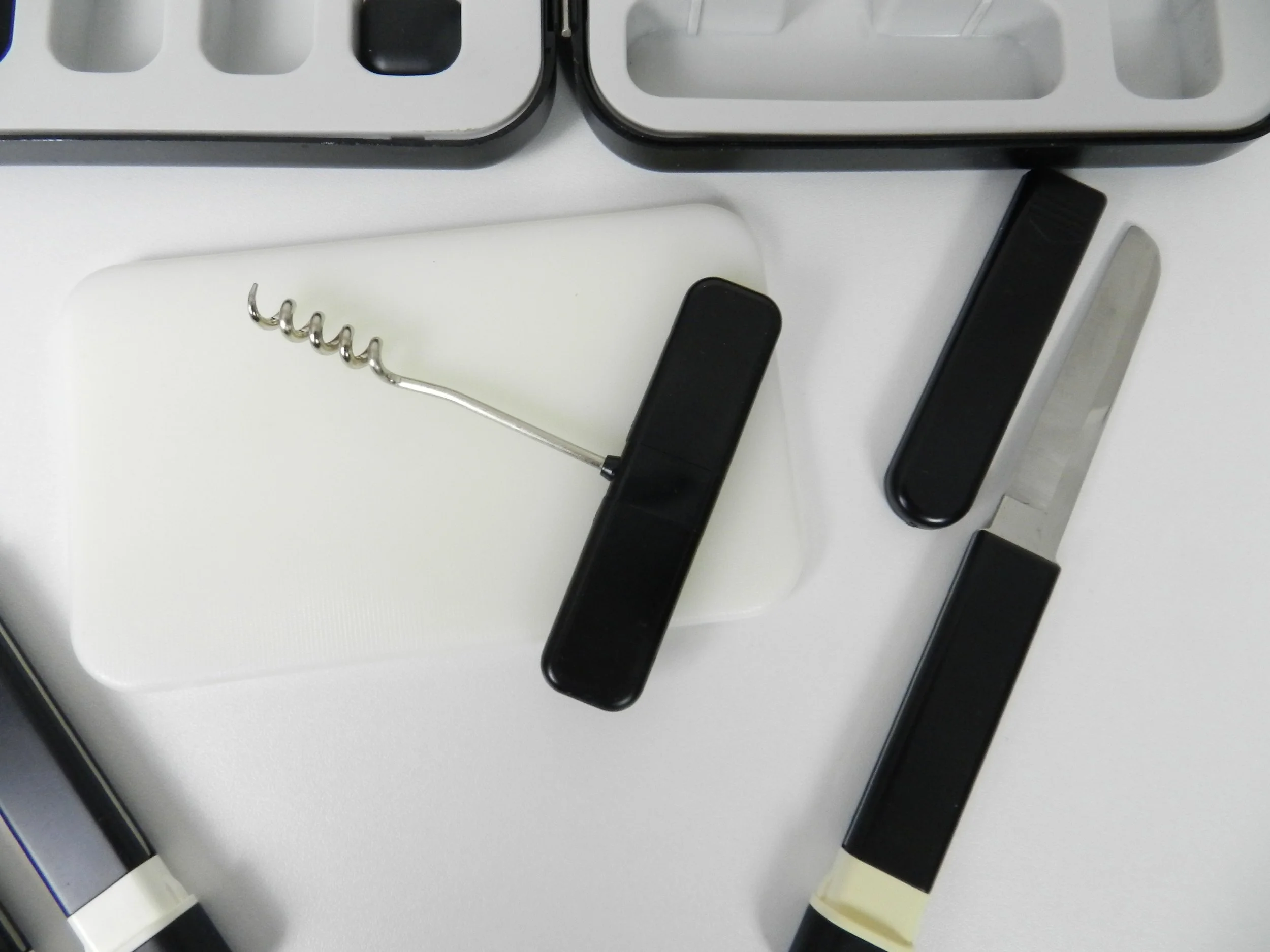 Post modern picnic set contains 2 spoons, 2 forks, cork screw, sharp knife in protective case, cutting board & heavy duty plastic travel case.  Japan, 1980s.