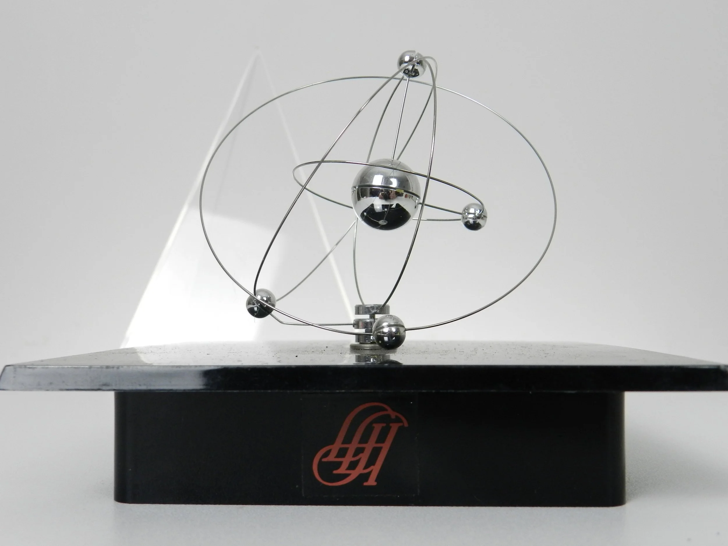 Space age planetary orbit clock in clear and black acrylic with chrome wires.  circa 1980s.