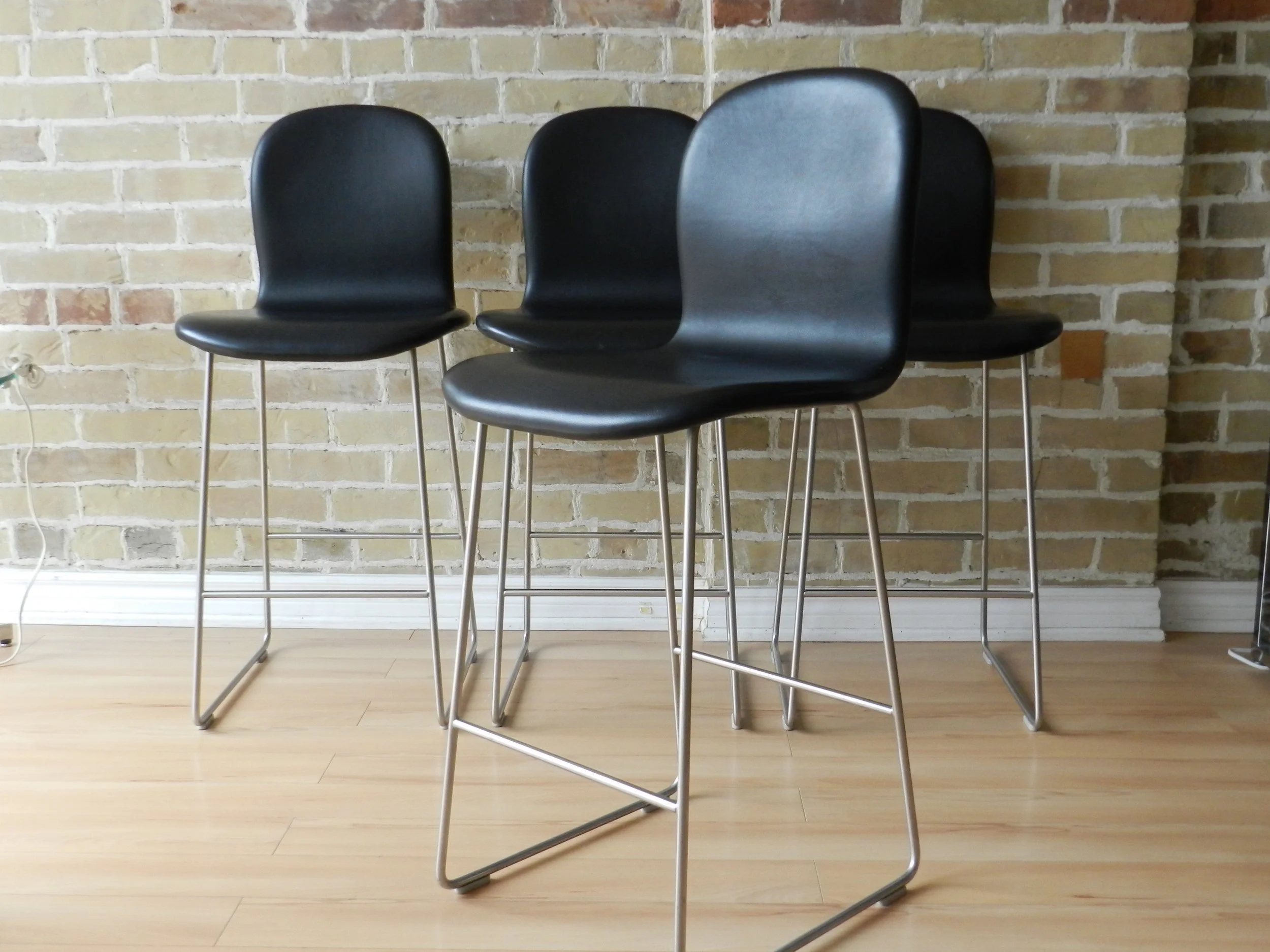 Set of four Tate Soft stools designed by Jasper Morrson for Cappellini. Black leather upholstery on steel base. Counter height.  Italy, 2021.