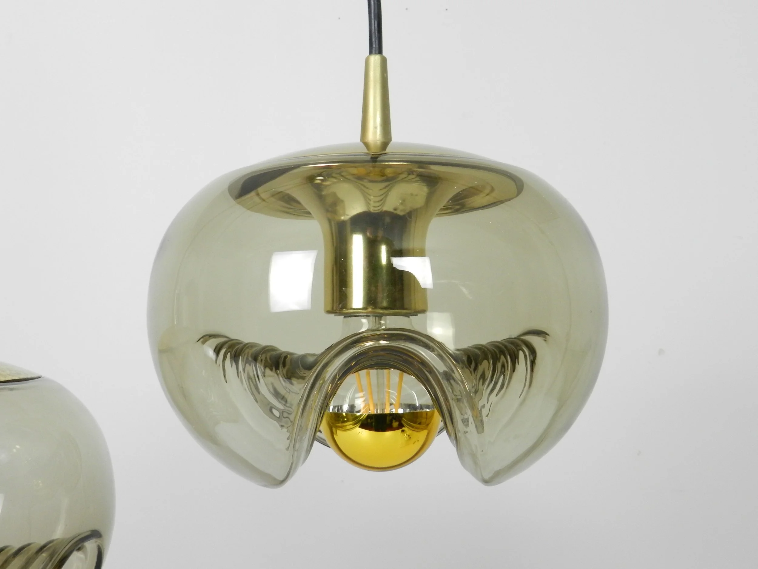 Brass and tinted glass pendant lamps by Peill and Putzler.  Germany, 1970s.