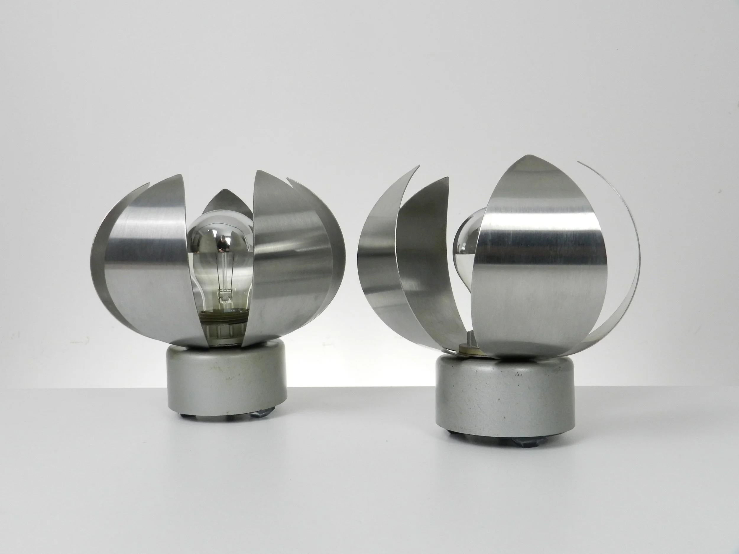 Pair of space age table or wall lamps in stainless steel.  France, 1970s.