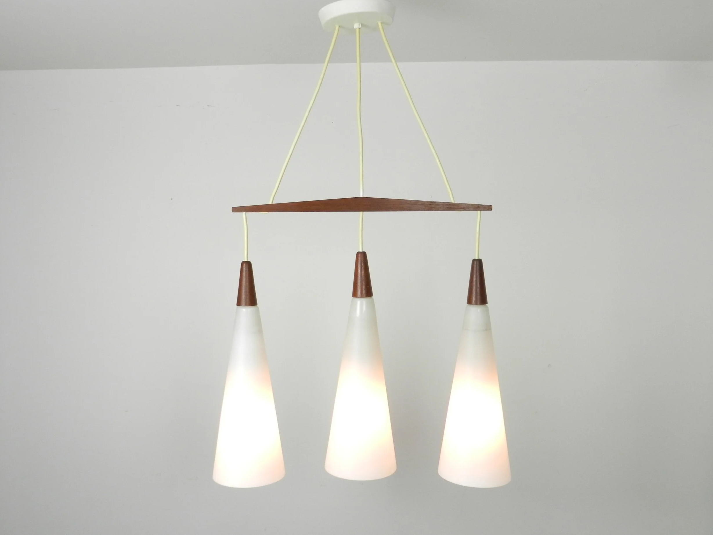 Three light Chandelier attributed to Holmegaard. Opaline glass with teak fittings.  Denmark, 1960s.