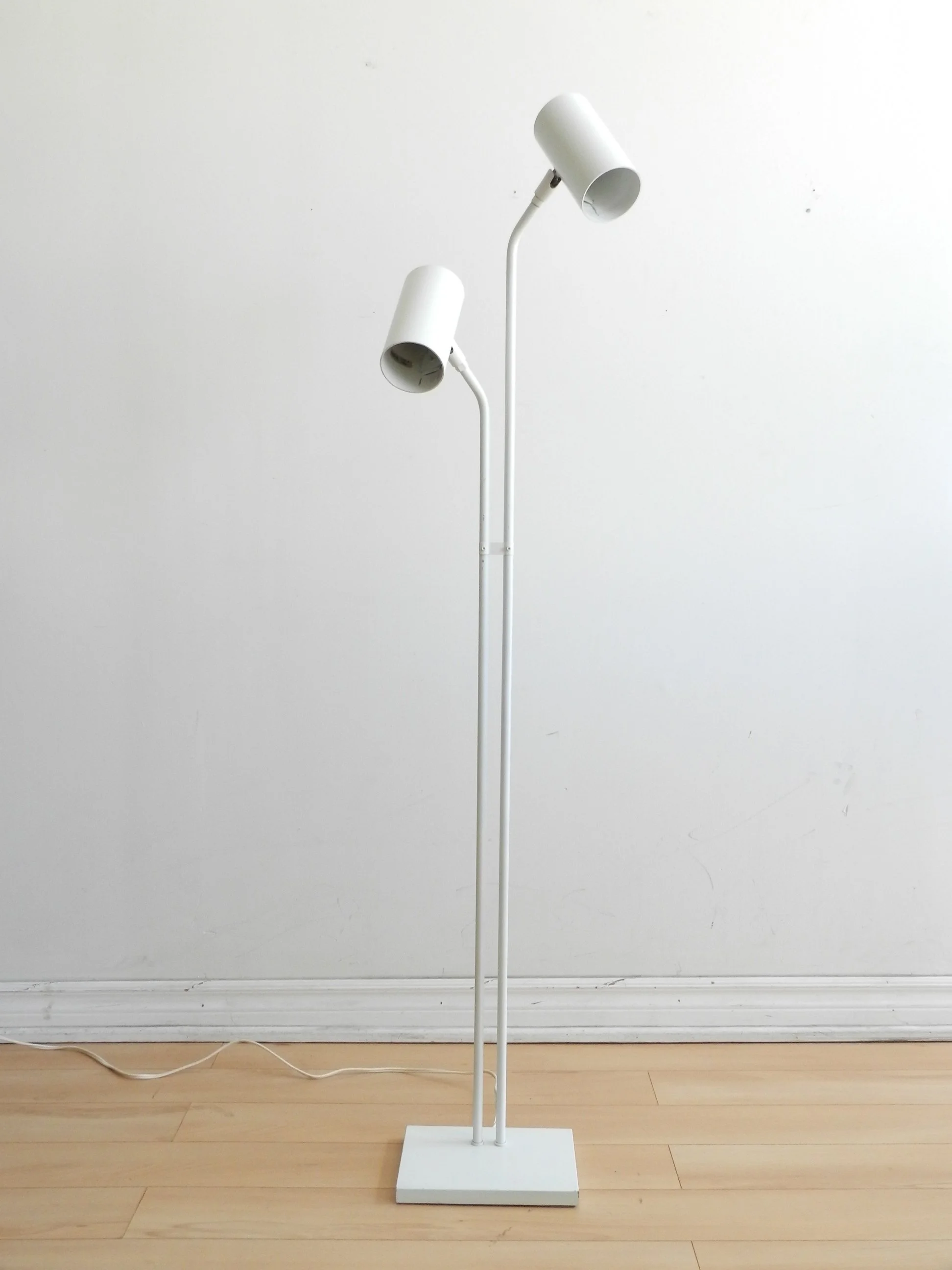 Modernist floor lamp in white enameled metal.  circa 1980s.