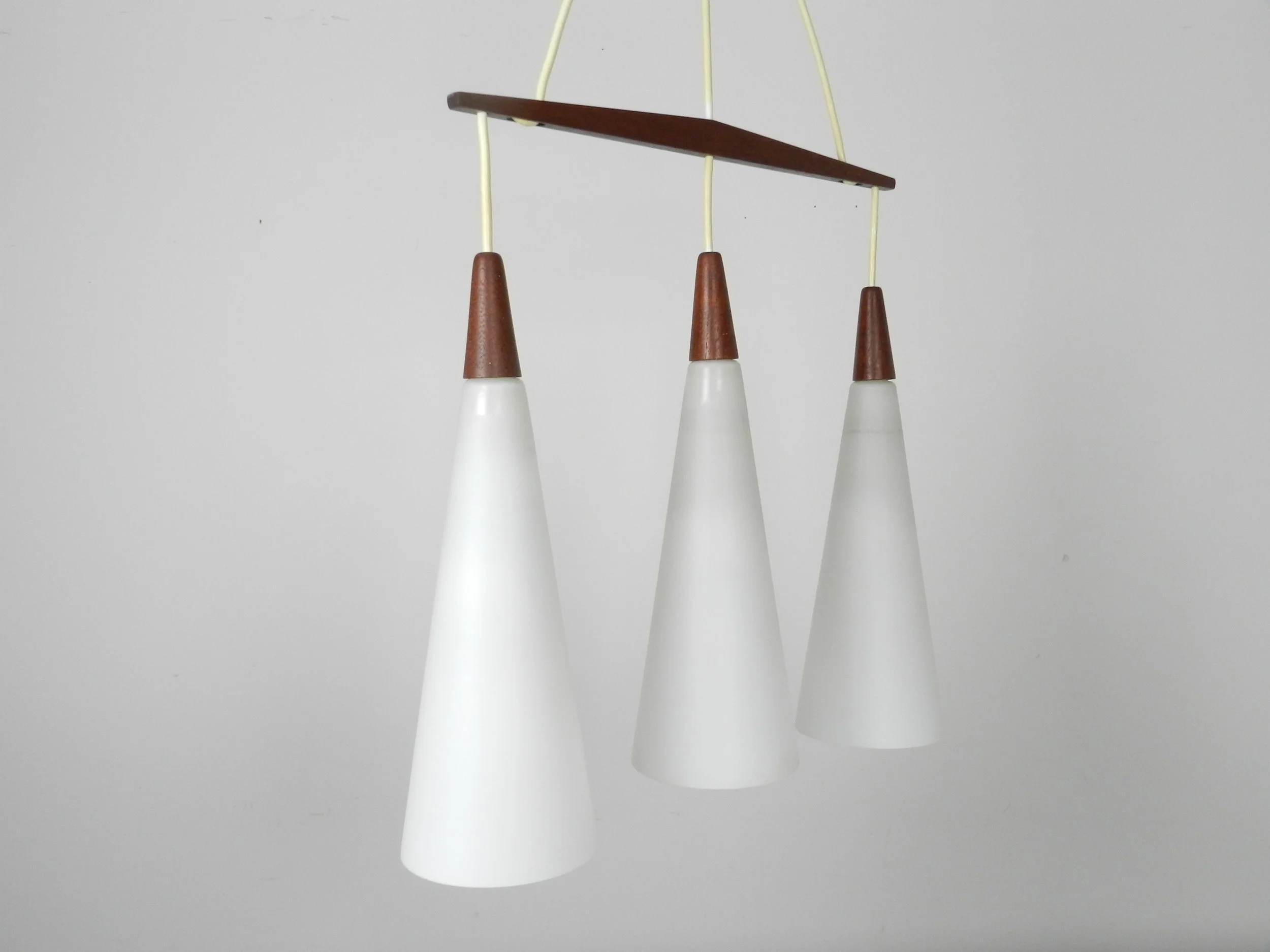 Three light Chandelier attributed to Holmegaard. Opaline glass with teak fittings.  Denmark, 1960s.