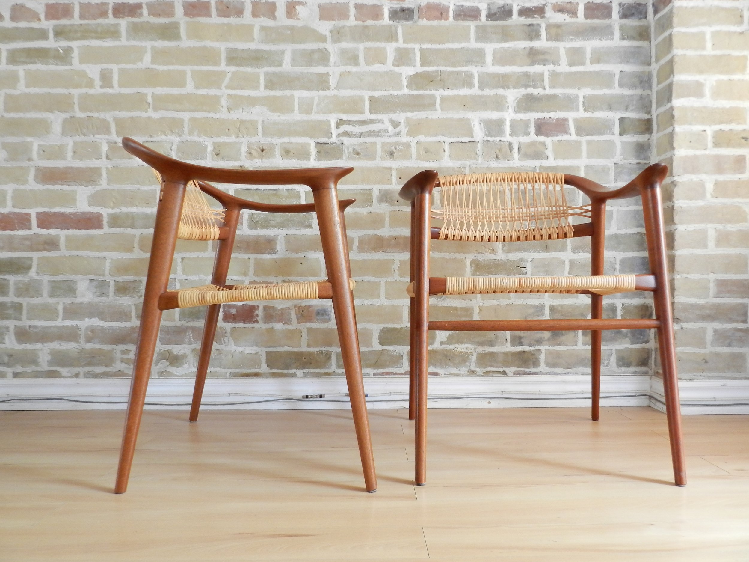 Pair of teak and cane “Bambi” arm chairs designed by Rolf Rastad and Adolf Relling for Gustav Bahus.  Norway, 1950s.