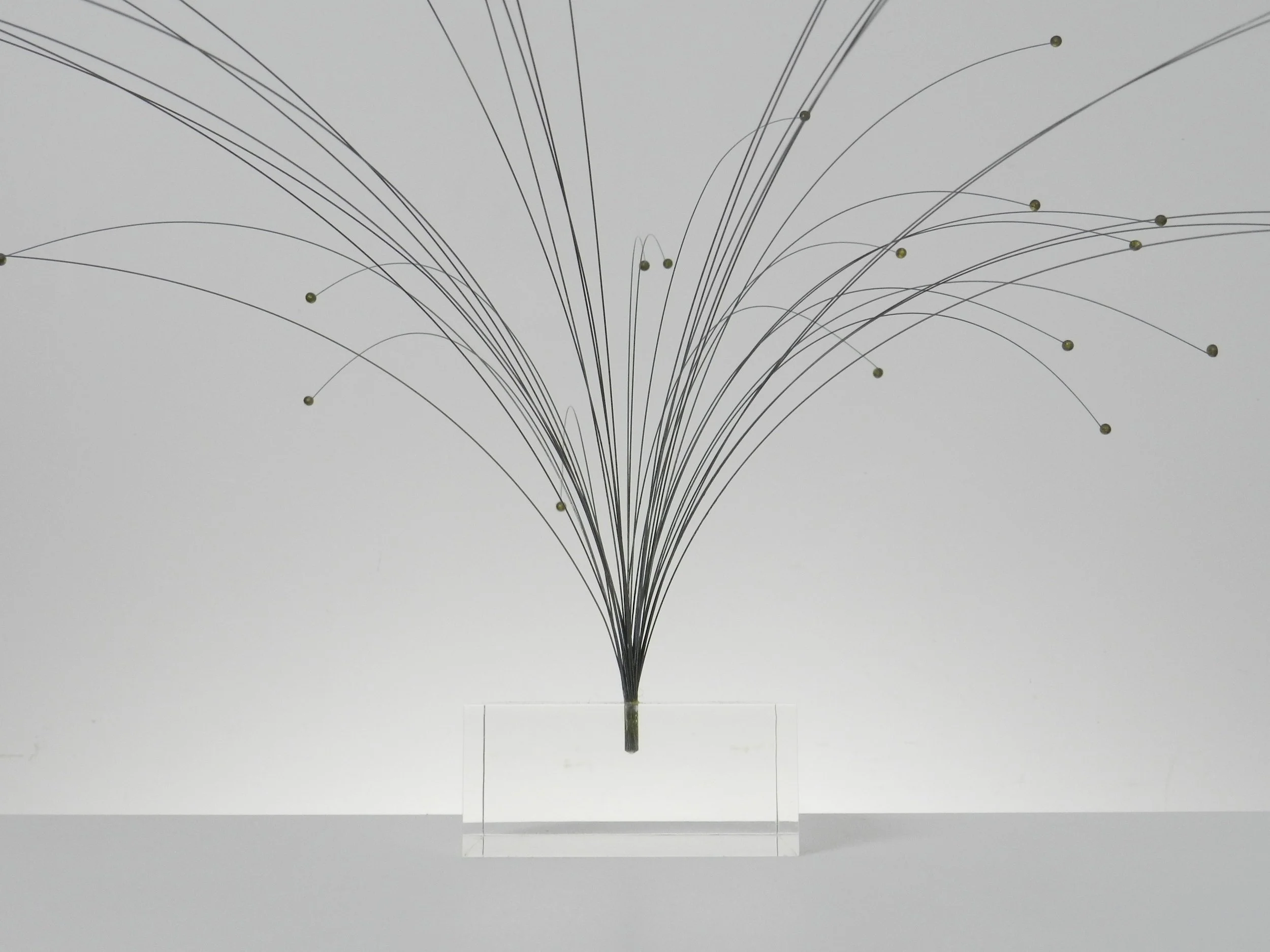 Kinetic spray sculpture in wire on lucite base.  circa 1970s.
