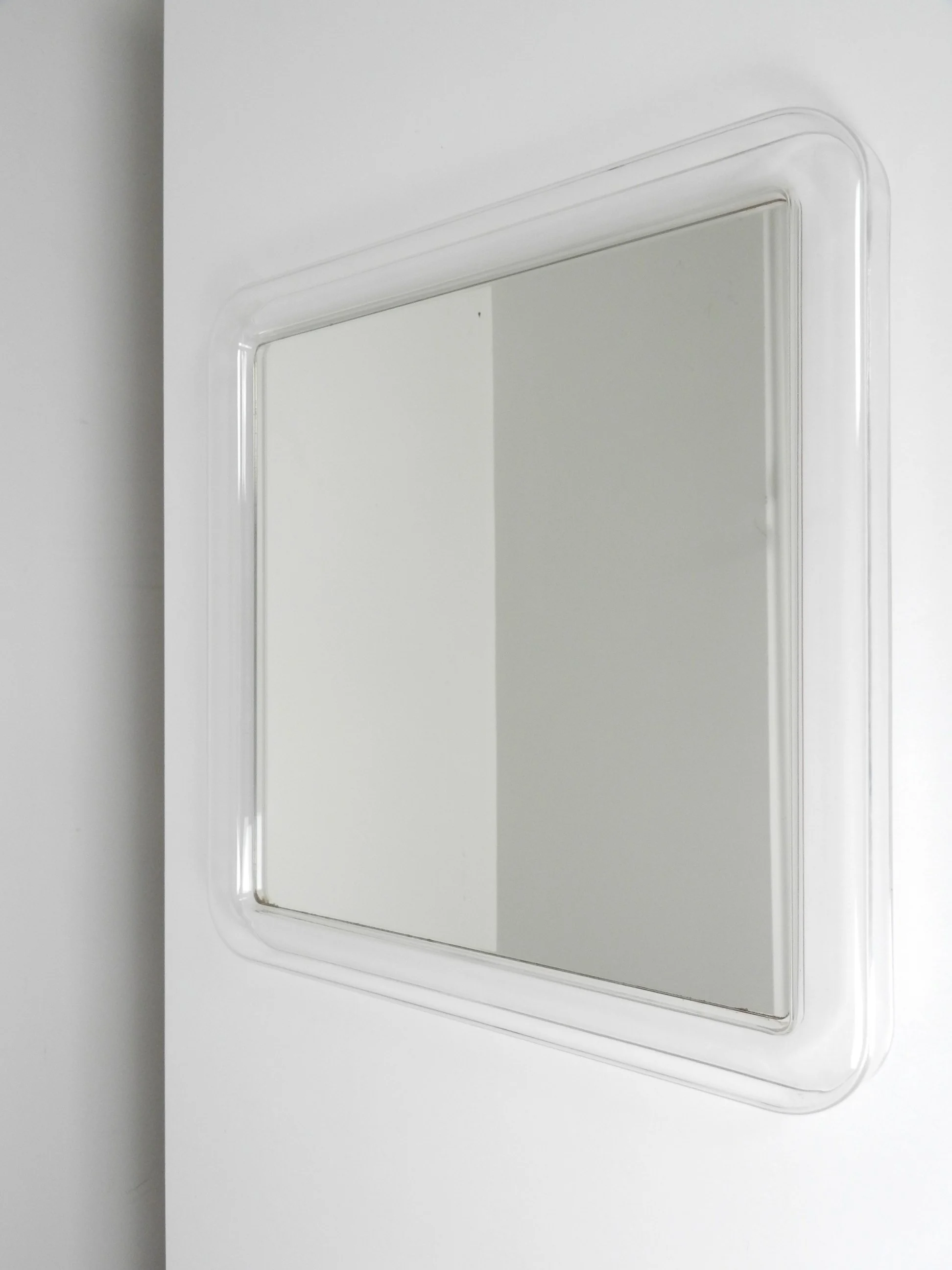 Modernist wall mirror with acrylic frame.  circa 1970s.