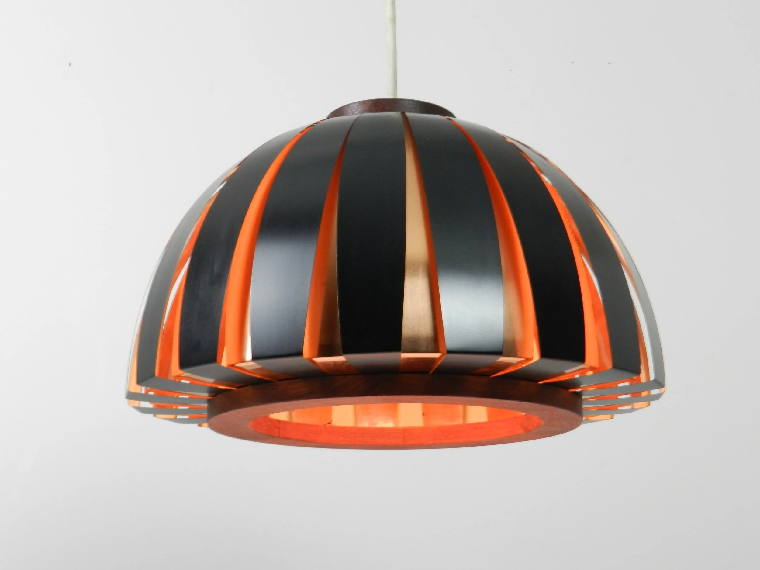 Fiesta pendant lamp designed by Svend Aage Holm Sorensen. Copper, enameled metal and teak.  Denmark, 1960s.