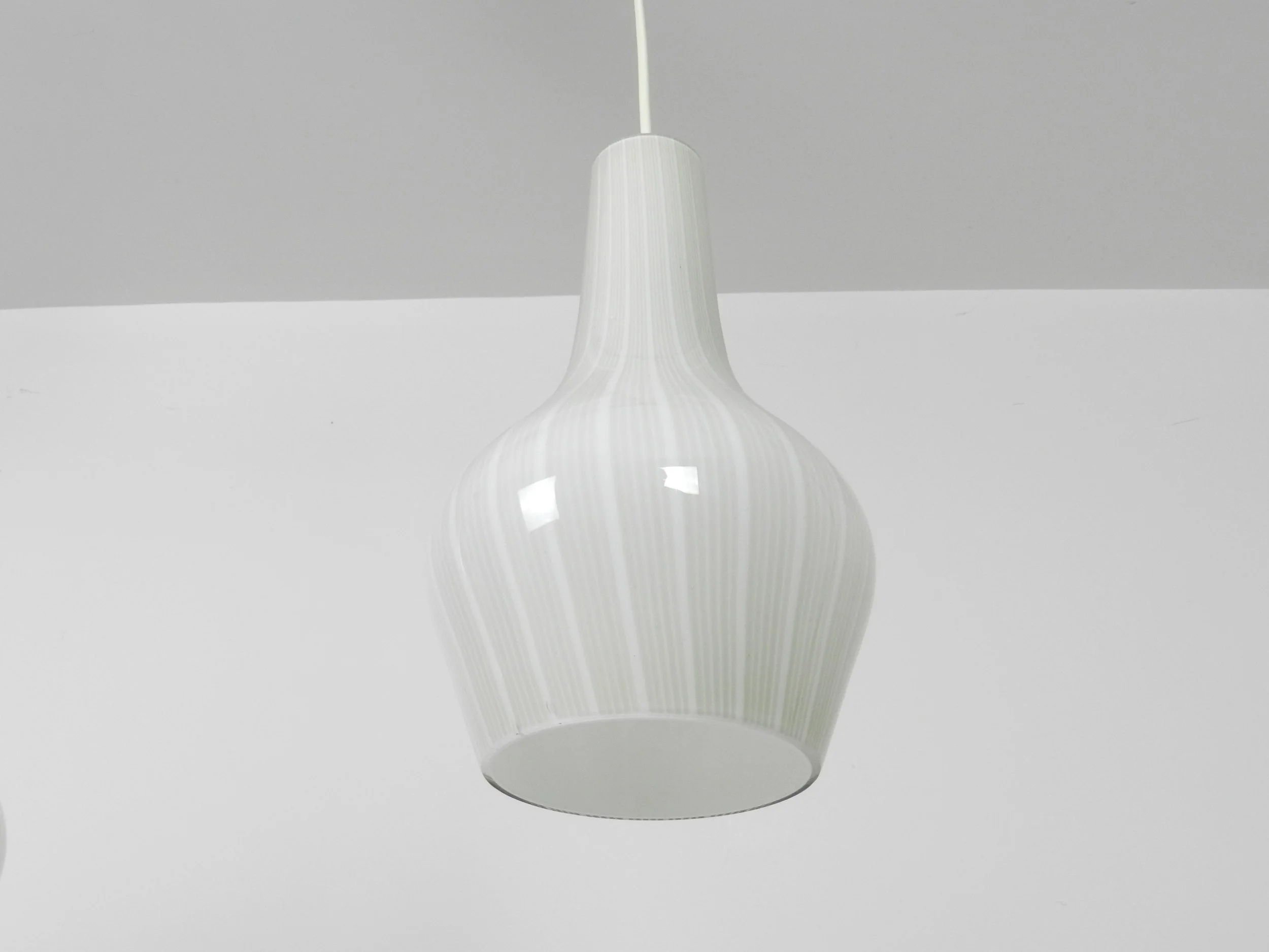 Triple pendant lamp in cased Murano glass with brass fixture. Designed by Massimo Vignelli for Venini.  Italy, 1960s.