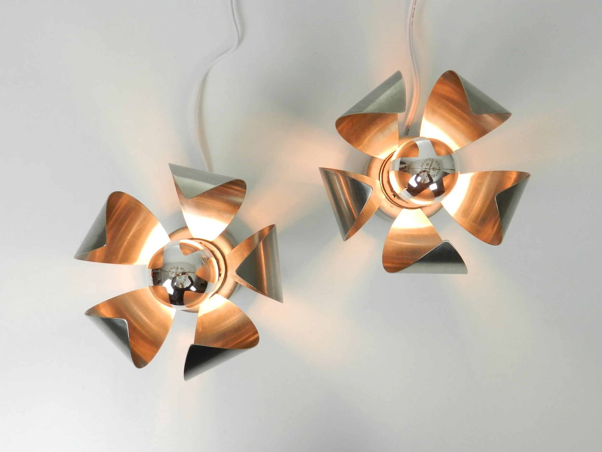 Pair of space age table or wall lamps in stainless steel.  France, 1970s.