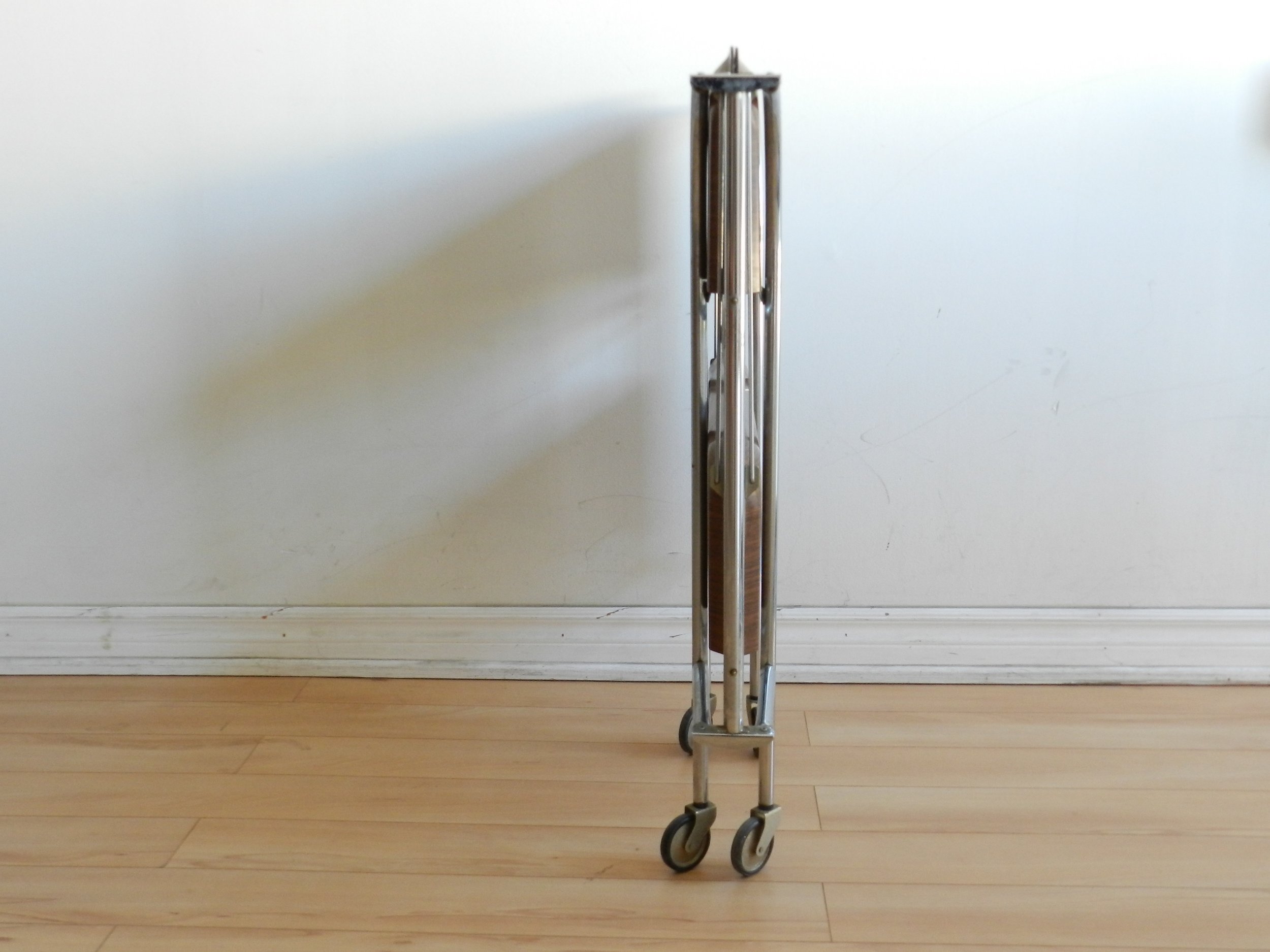 Vintage folding bar cart in chrome with fromica shelves.  Germany, 1960s.