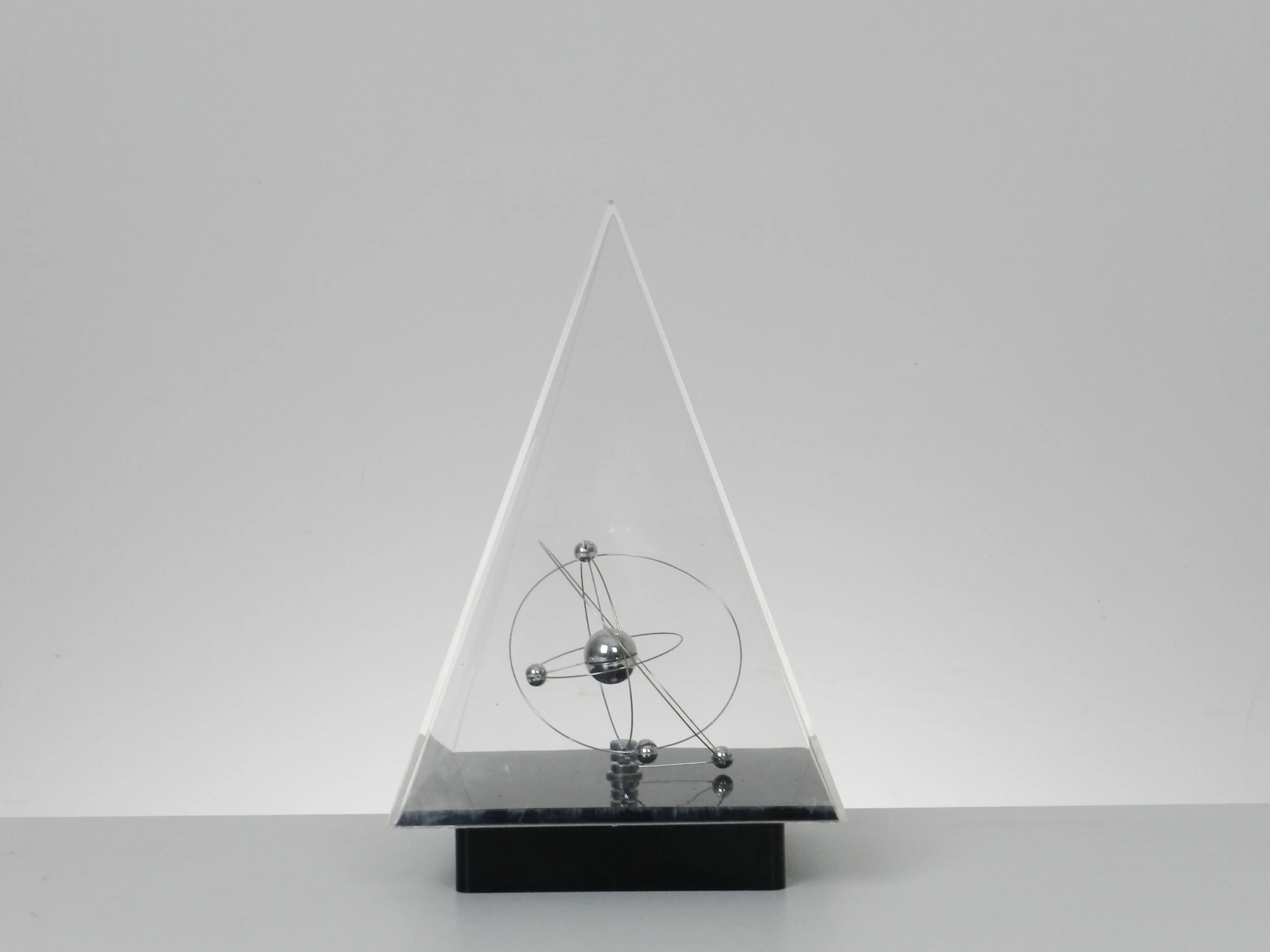 Space age planetary orbit clock in clear and black acrylic with chrome wires.  circa 1980s.