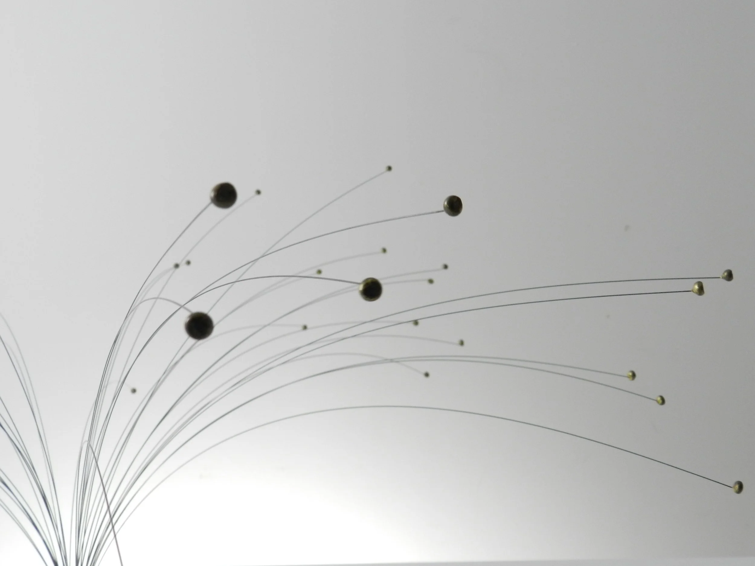 Kinetic spray sculpture in wire on lucite base.  circa 1970s.