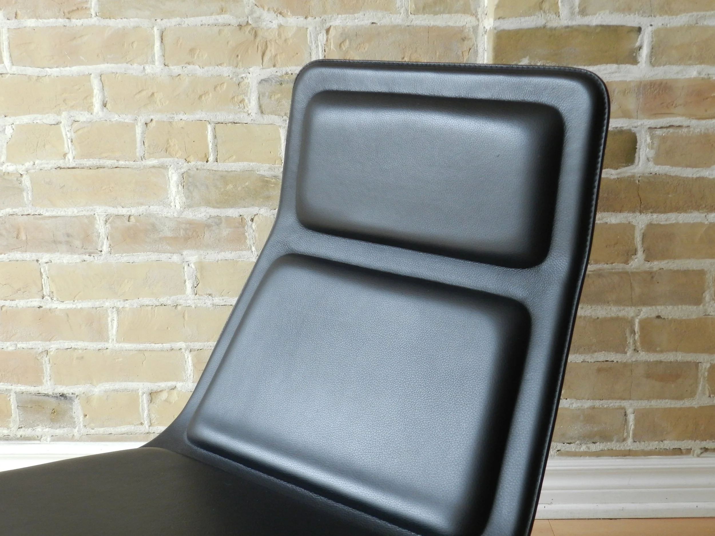 Pair of Low Pad lounge chairs designed by Jasper Morrison for Cappellini. Black leather upholstery on steel bases.  Italy, 1999.