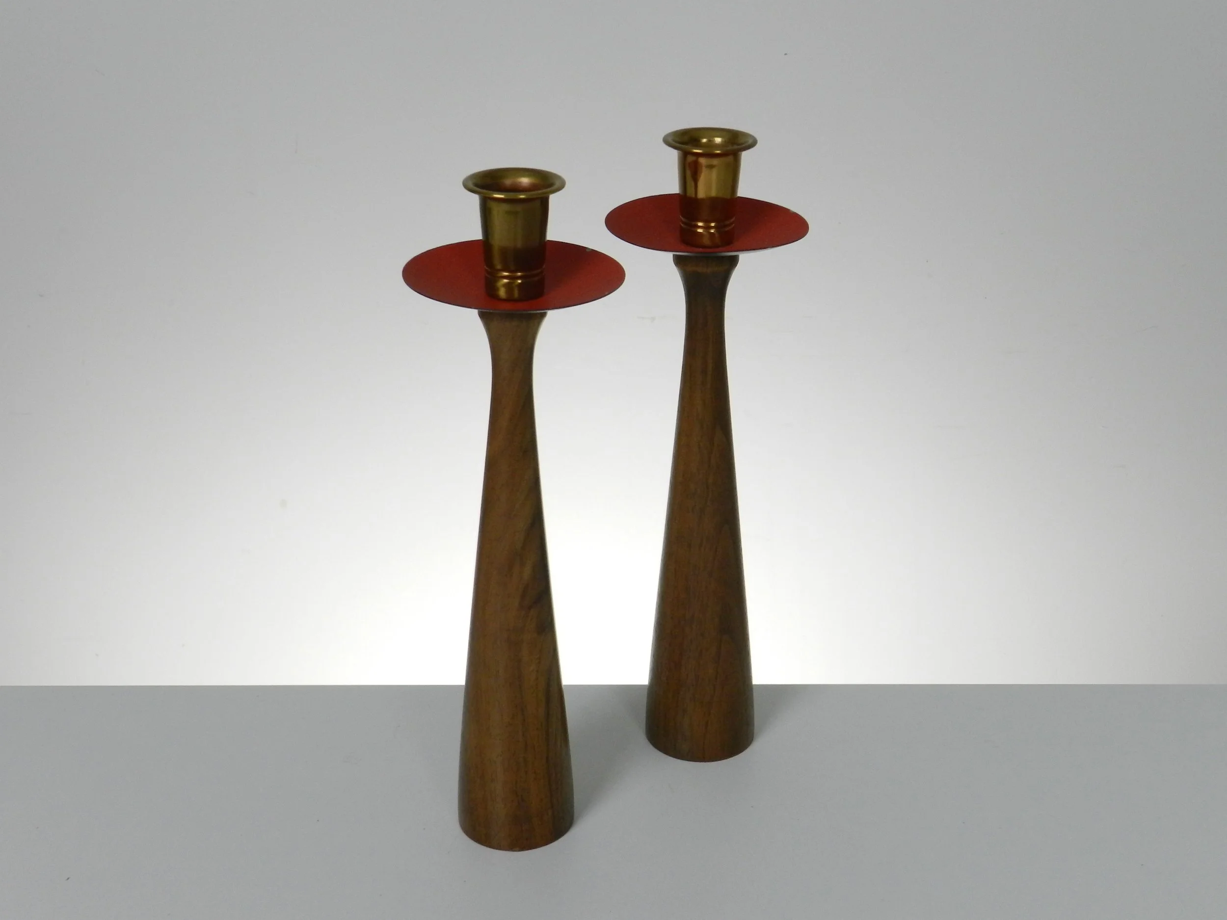 Mid century candle holders in walnut, brass and enameled metal.  Denmark, 1960s.