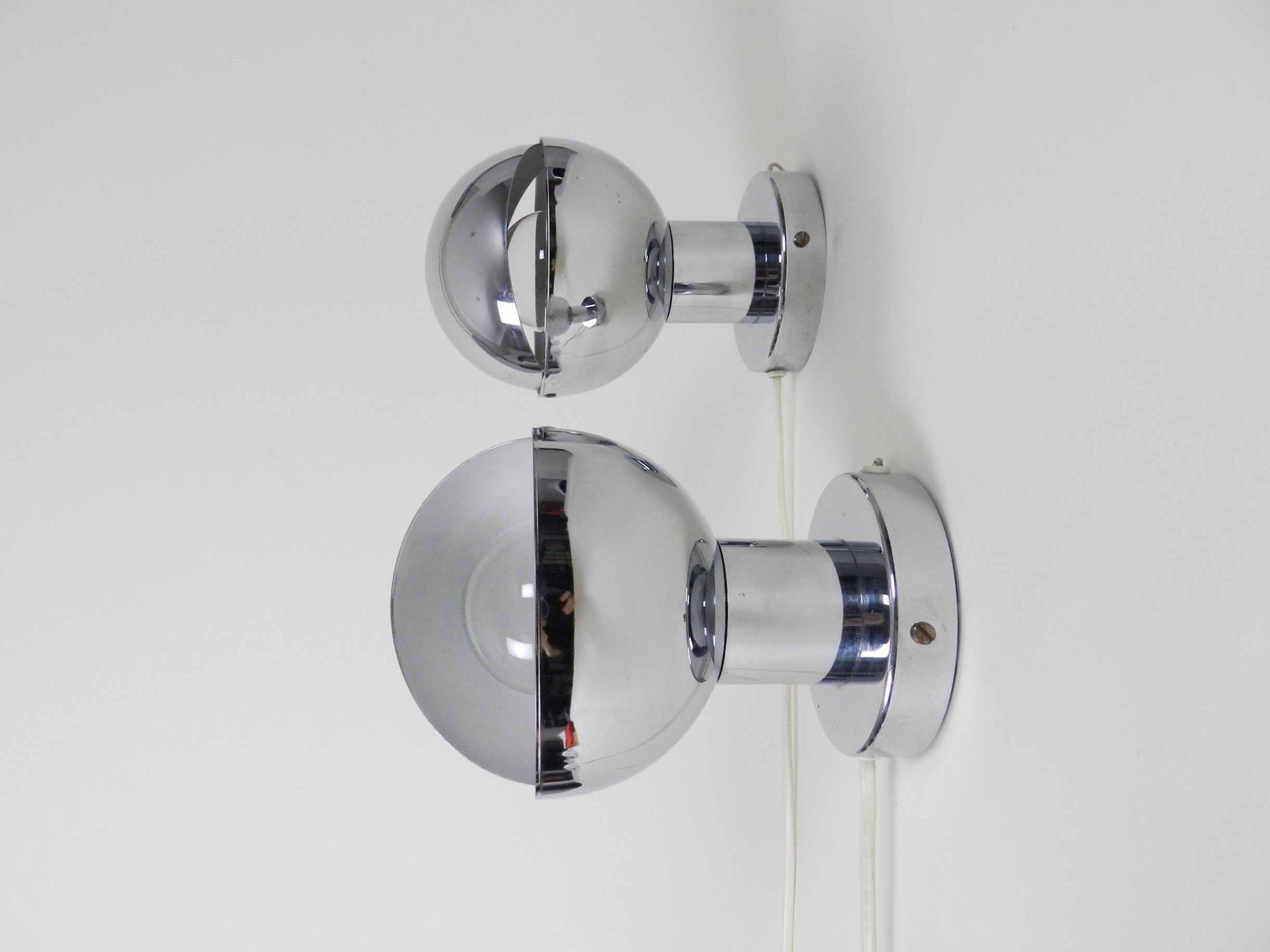 Pair of space age chrome eclipse wall lamps. Netherlands, 1970s.