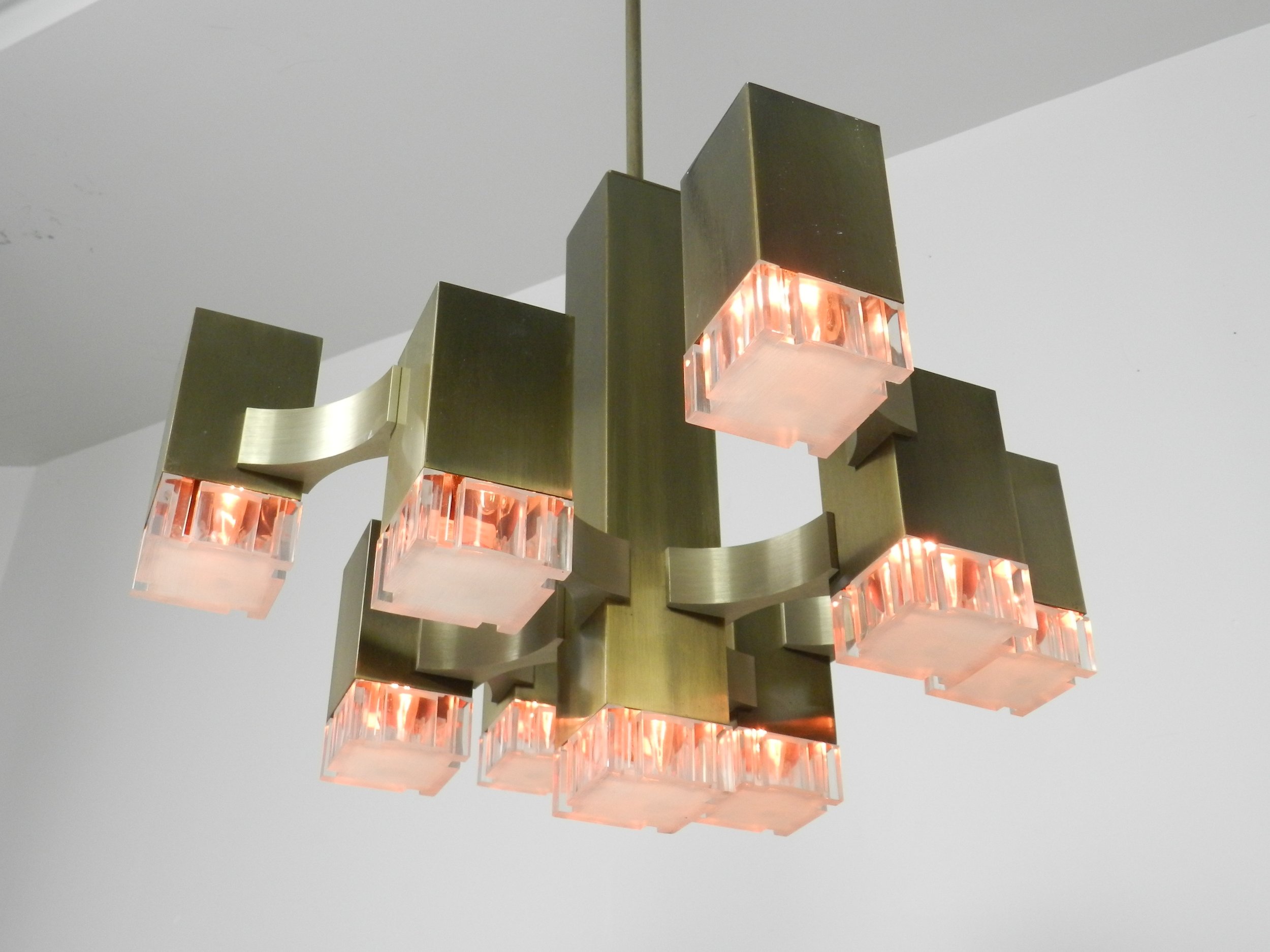 Modernist nine light “Cubic” chandelier designed by Gaetano Sciolari. In bronze plated metal with acrylic diffusers.  Italy, 1960s.