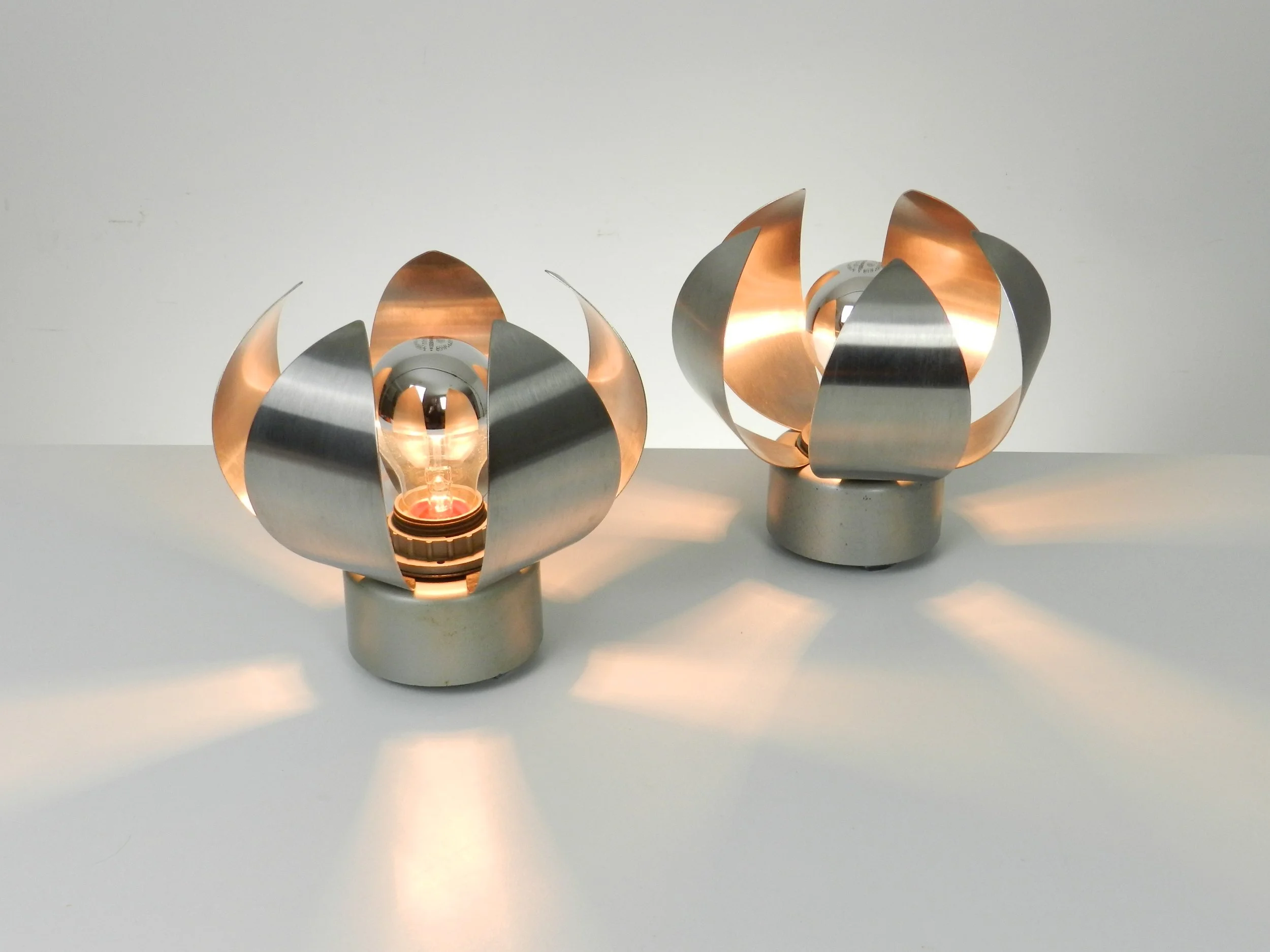 Pair of space age table or wall lamps in stainless steel.  France, 1970s.