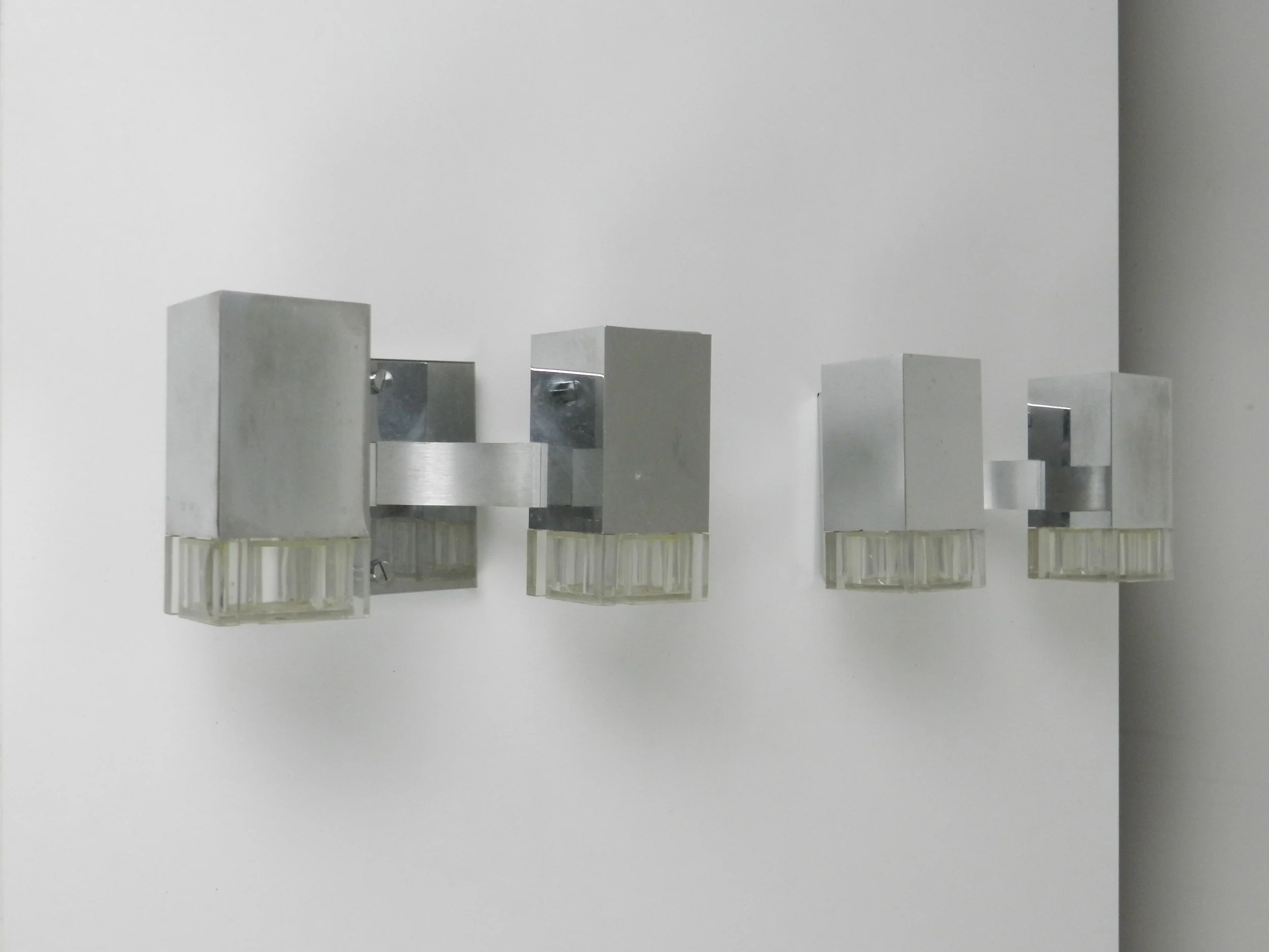 Pair of chrome and acrylic Cubic wall sconces designed by Gaetano Sciolari for Sciolari.  Italy, 1970s.