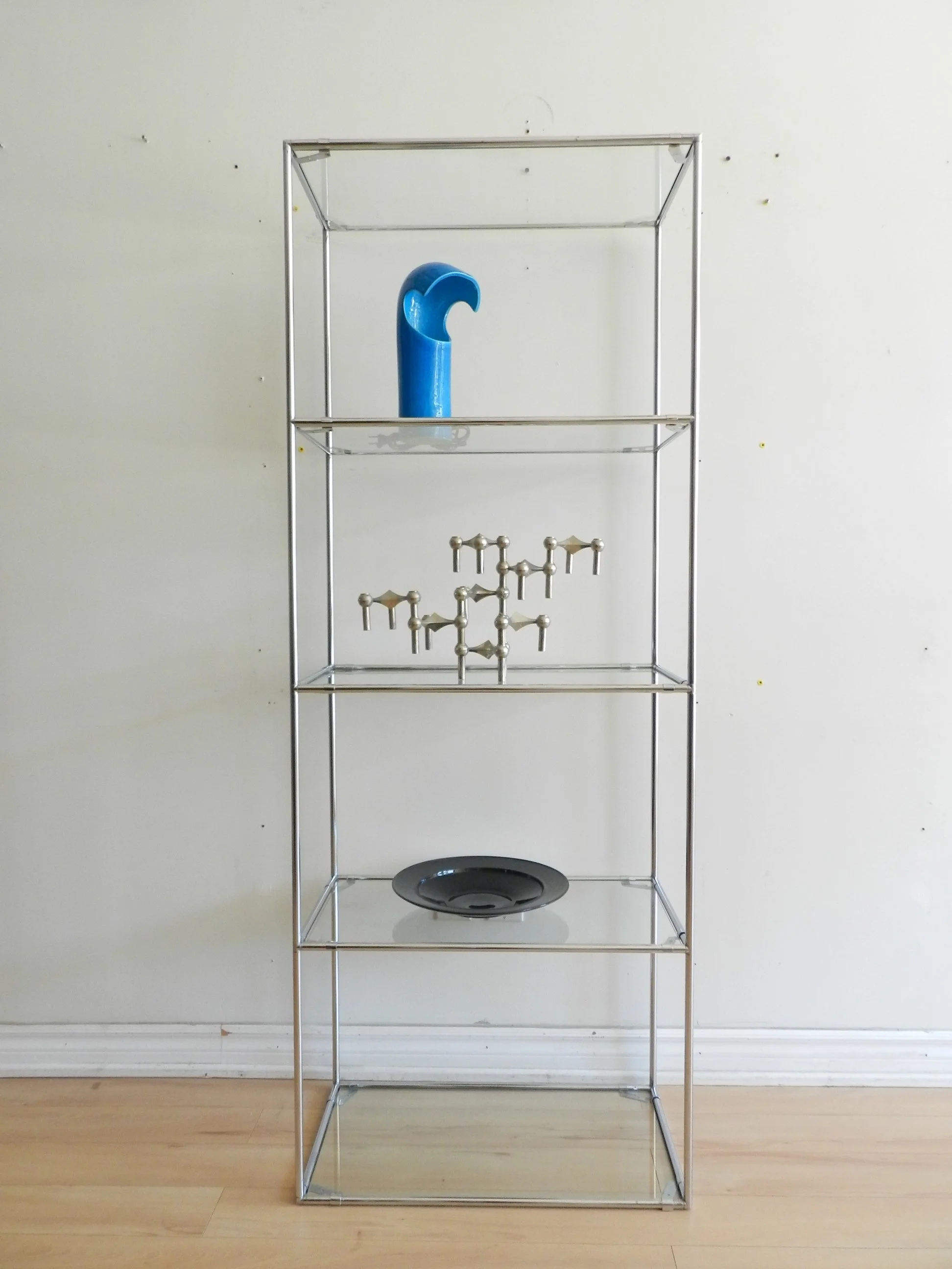 Pair of Abstracta chrome and glass modular shelf units designed by Poul Cadovius for Royal System.  Denmark, 1970s.