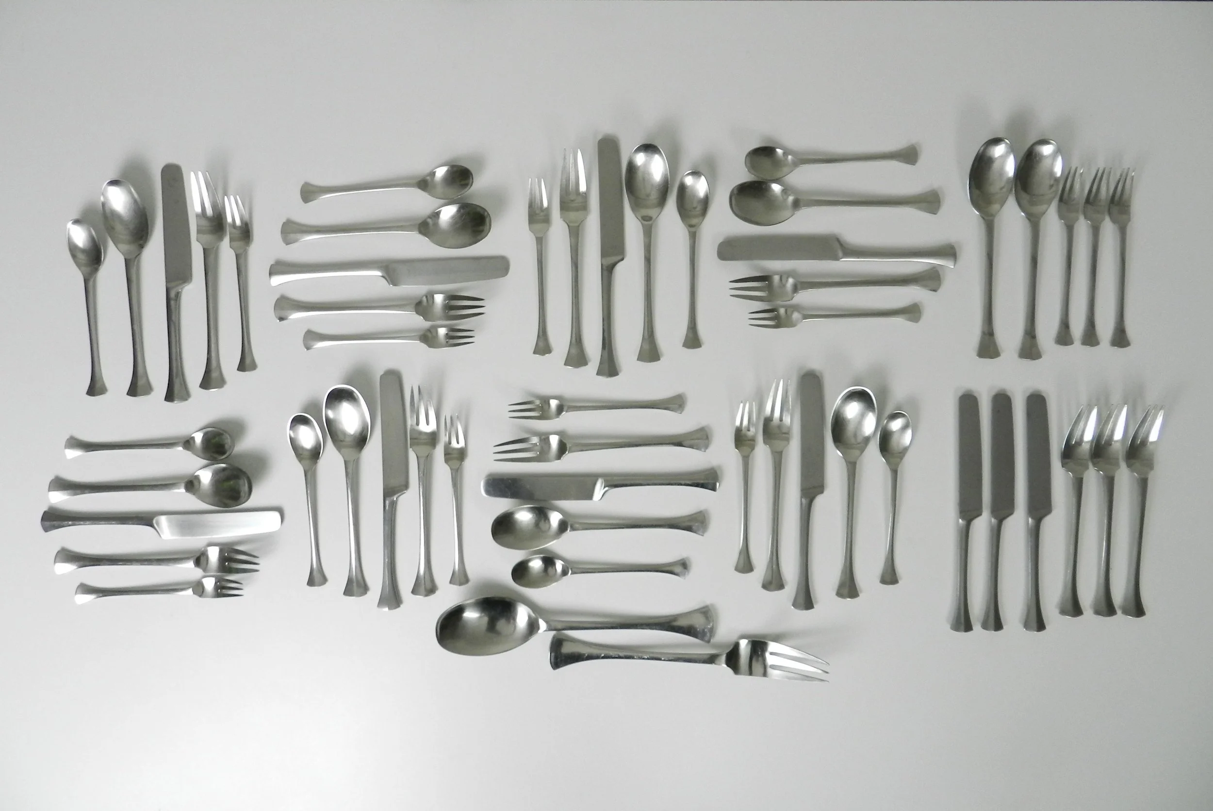 Stainless steel Thistle flatware set designed by Jens Quistgaard for Dansk. France, 1960s.