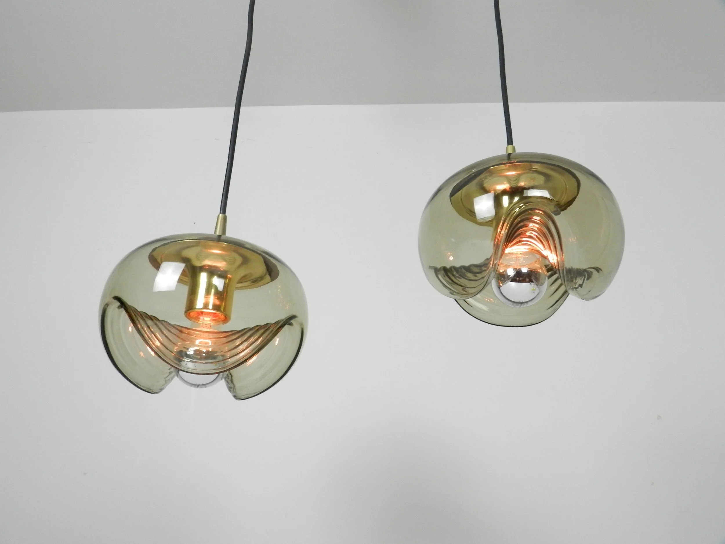 Brass and tinted glass pendant lamps by Peill and Putzler.  Germany, 1970s.
