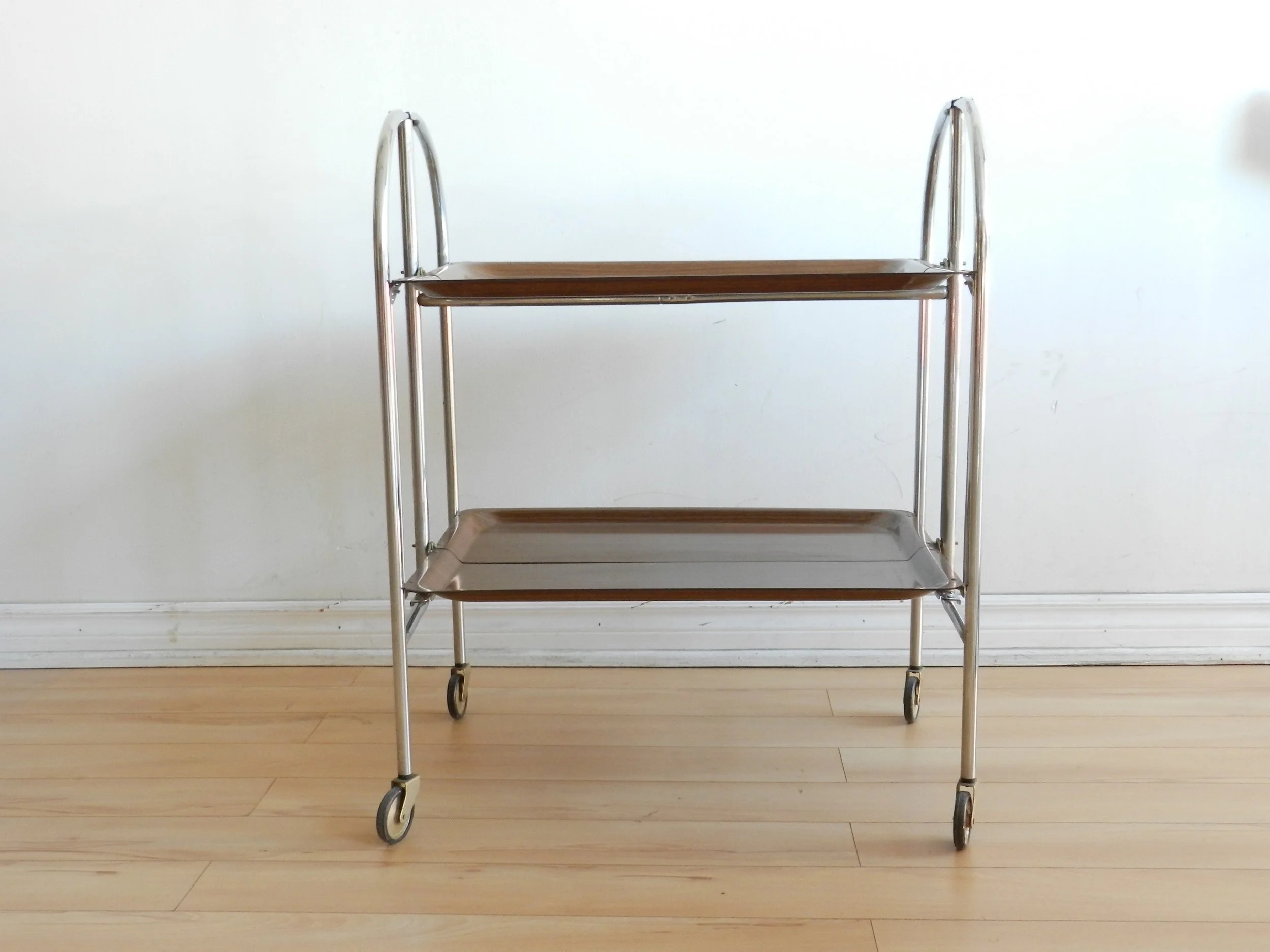 Vintage folding bar cart in chrome with fromica shelves.  Germany, 1960s.